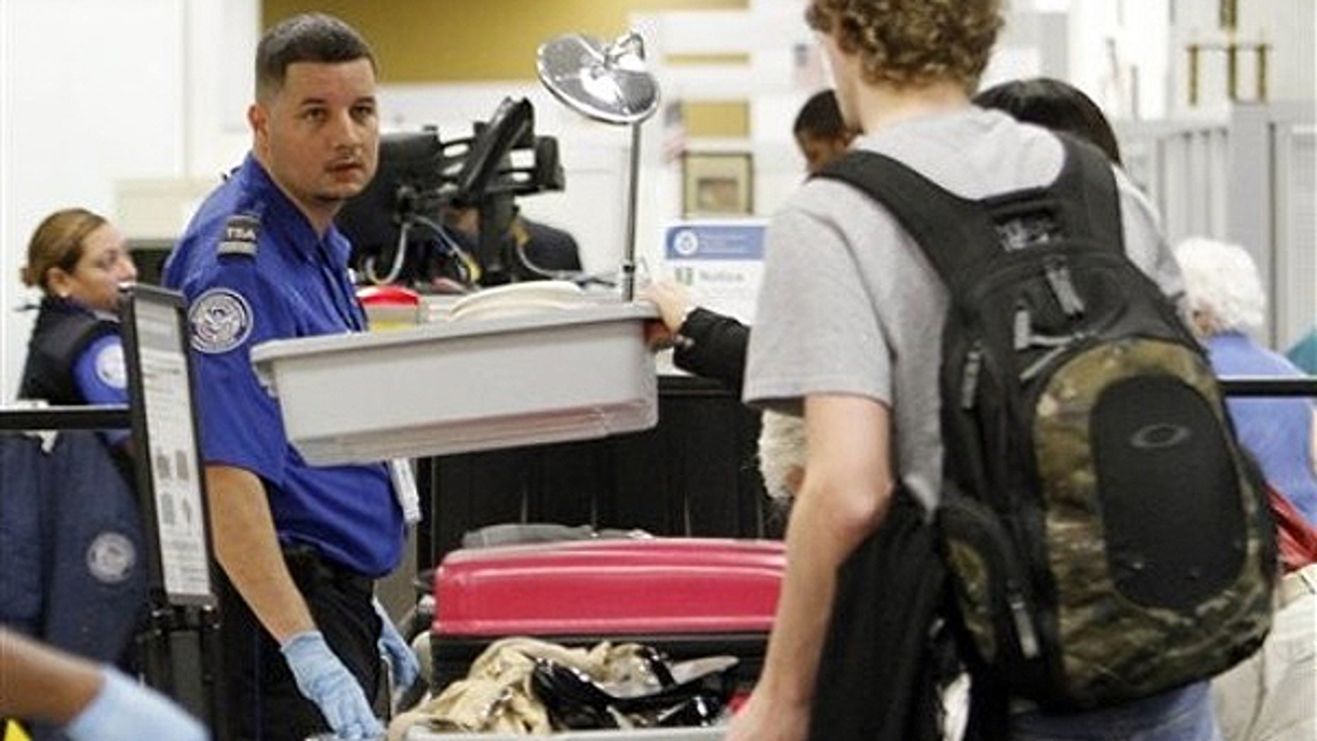 Dec. 23, 2010: A TSA officer checks passengers personal belongings at the X-ray machine at Miami International Airport in Miami.