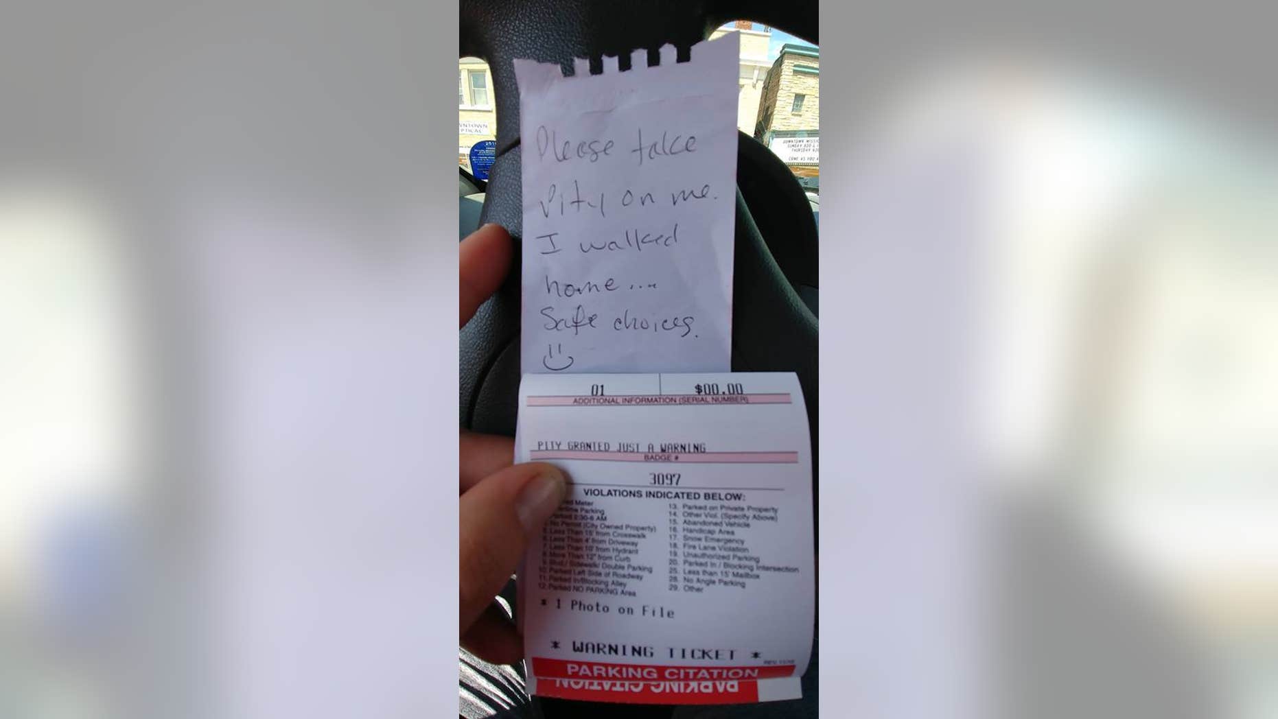 A Wisconsin officer issued a "pity" warning to a driver after finding a funny note left on the individual's car parked in an overdue meter spot. (Wausau Police Department)