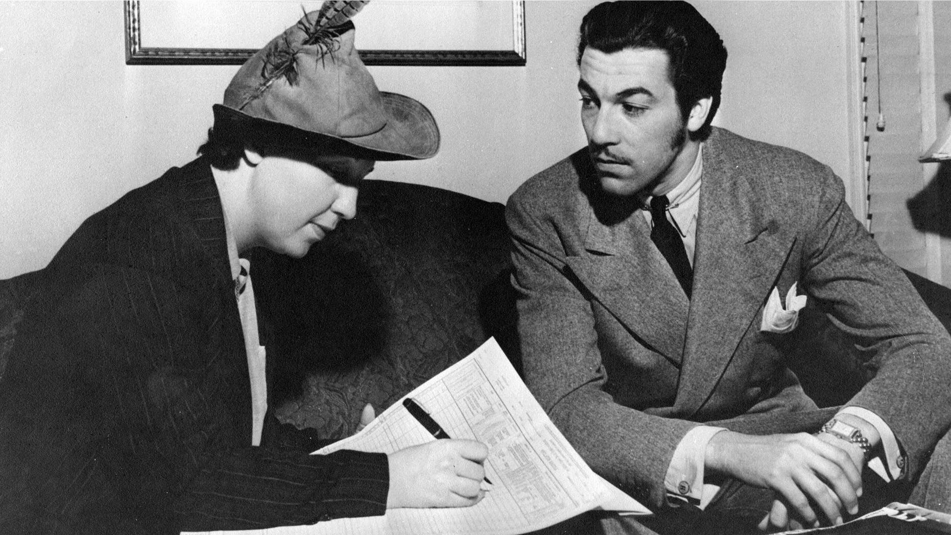In this photo provided by the National Archives at College Park, an enumerator interviews actor Cesar Romero, right, to get data for the 1940 Census. Veiled in secrecy for 72 years because of privacy protections, the 1940 U.S. Census is the first historical federal decennial survey to be made available on the Internet initially rather than on microfilm. (AP Photo/National Archives at College Park)