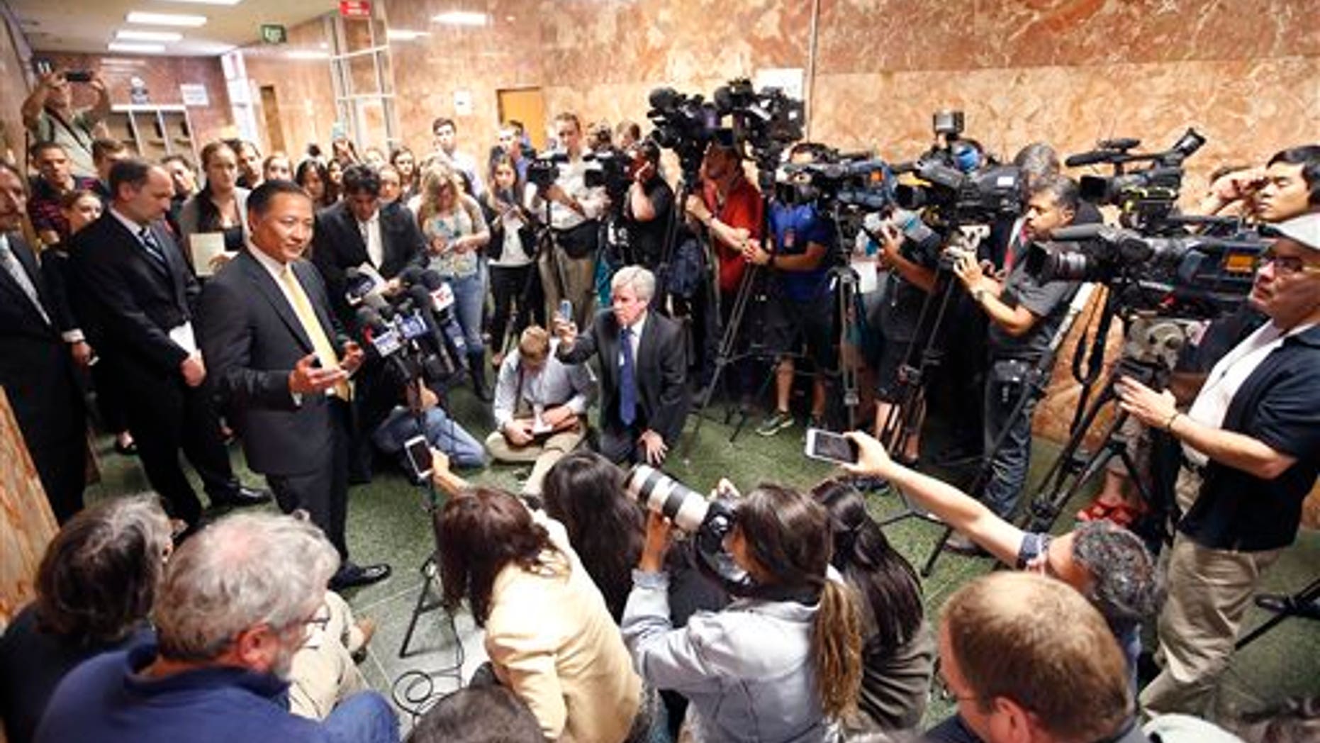 San Francisco Public Defender Jeff Adachi, left, talks to members of the media after Francisco Sanchez's arraignment Tuesday, July 7, 2015, in San Francisco.