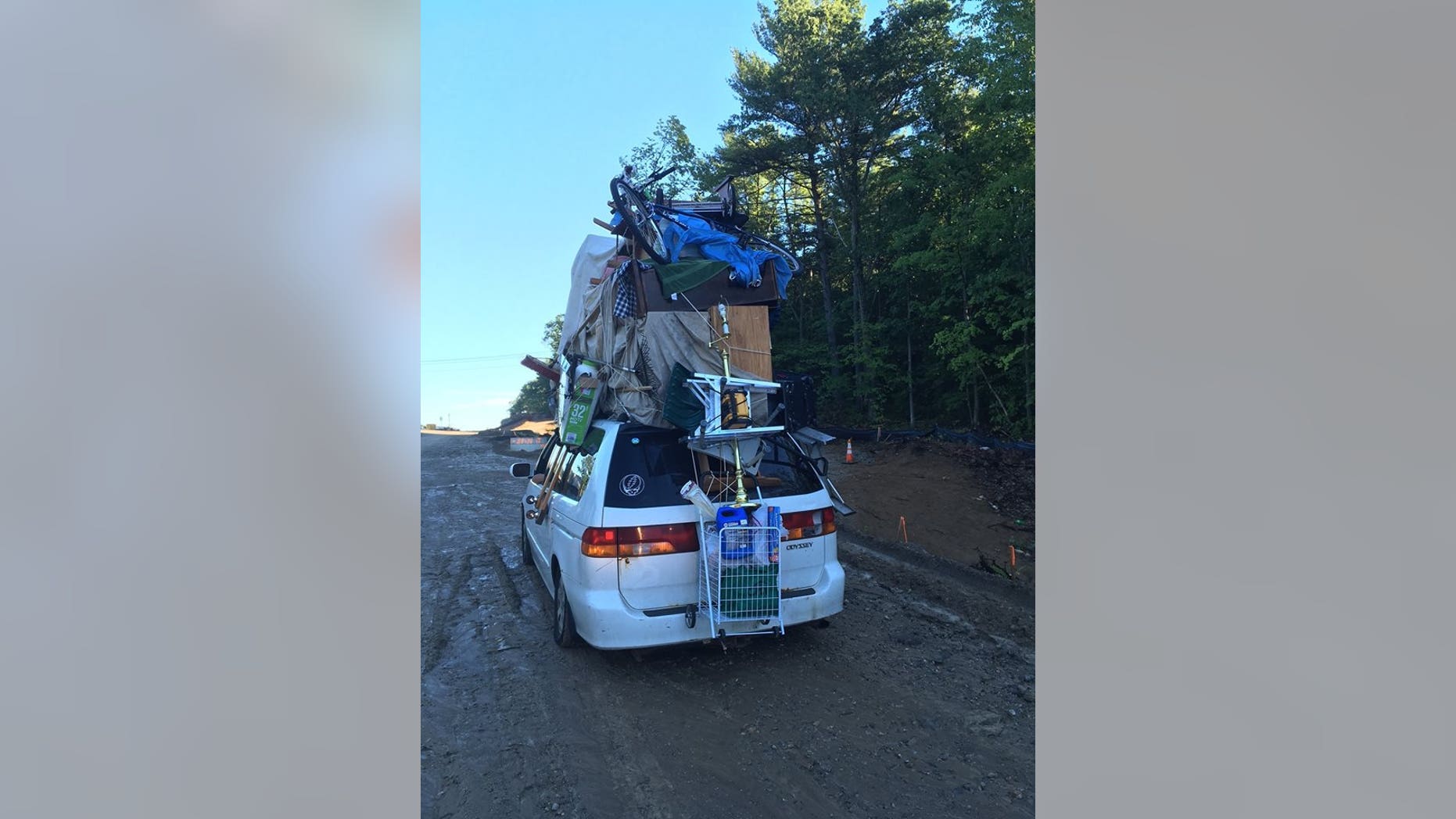 The van was pulled over Wednesday on Interstate 93 with several items -- including a bike and furniture pieces -- attached, police said. (New Hampshire Police Department)