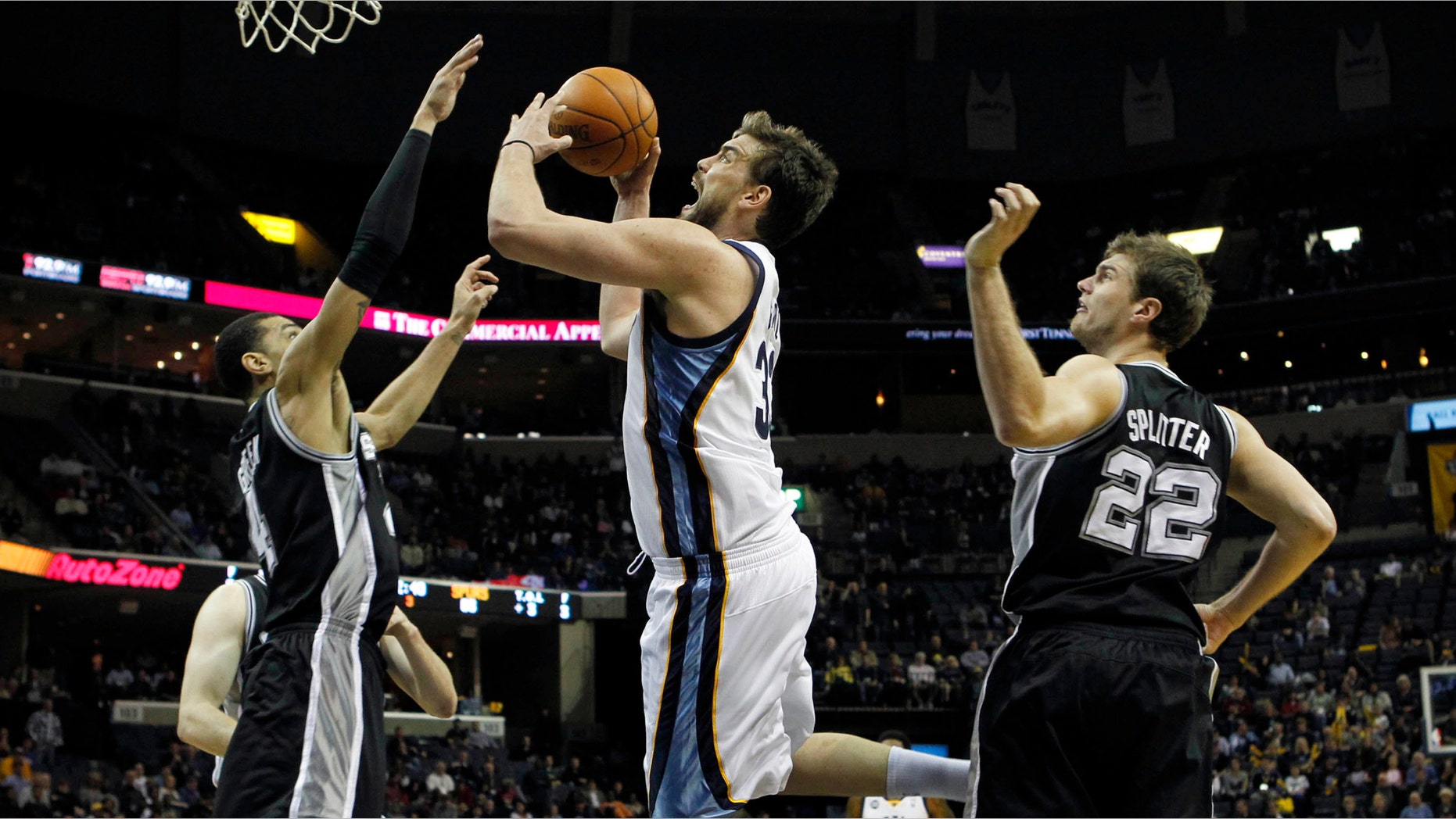 Memphis Grizzlies center Marc Gasol, of Spain, (33) shoots under pressure by San Antonio Spurs forward Danny Green (4) in the second half of an NBA basketball game on Monday, Feb. 6, 2012, in Memphis, Tenn. (AP Photo/Jim Weber)