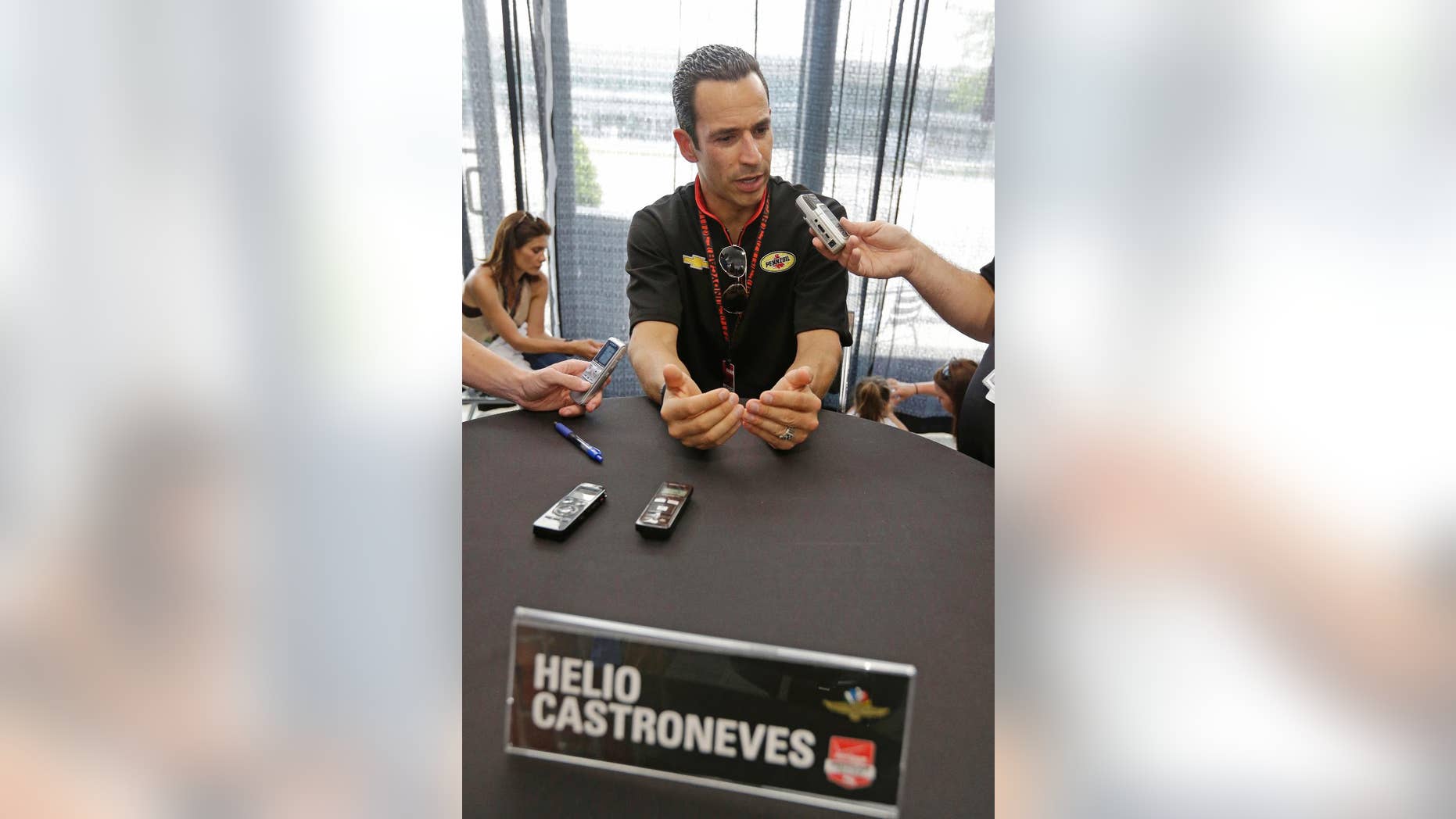 Helio Castroneves, of Brazil, responds to a question during media interview for the Indianapolis 500 IndyCar auto race at the Indianapolis Motor Speedway in Indianapolis, Thursday, May 22, 2014. (AP Photo/Darron Cummings)