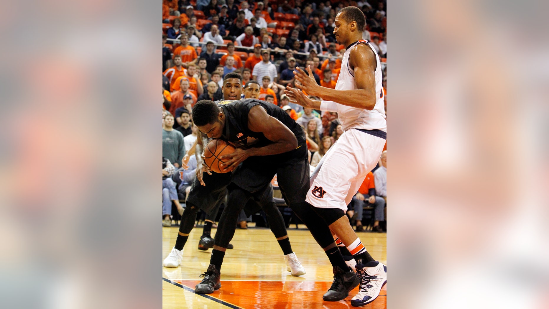 CORRECTS MISSOURI FIRST NAME TO TORREN FROM TORRENCE - Missouri's Torren Jones steps on the line as he rebounds a shot away from Auburn's Asauhn Dixon-Tatum, right, during the second half of an NCAA college basketball game on Saturday, Jan. 11, 2014, in Auburn, Ala. Missouri won 70-68. (AP Photo/Butch Dill)