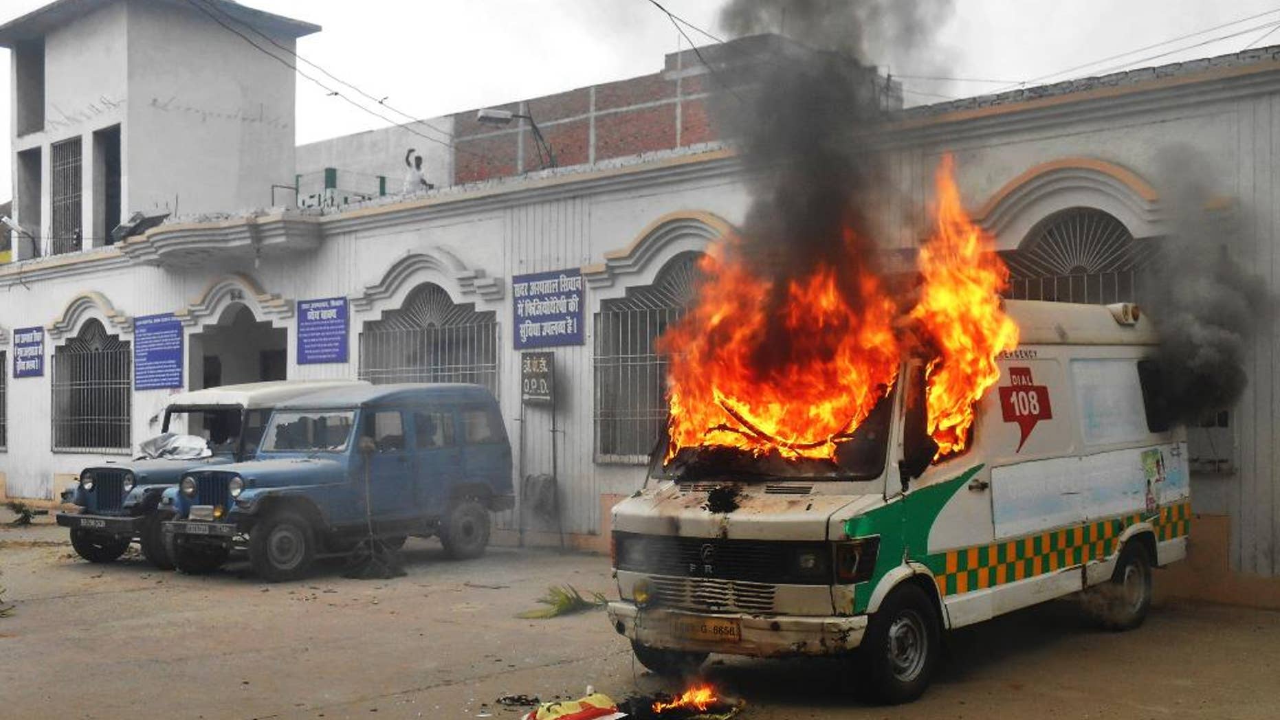 An ambulance goes up in flames after it was set fire by angry villagers at a government hospital in Siwan, about 200 kilometers (125 miles) north of Patna, Bihar state, India, Monday, April 20, 2015. Villagers who took injured students of a road accident to this hospital became incensed when they discovered no doctors were present. About 100 people attacked the hospital in anger and burned six vehicles, including this ambulance. (AP Photo/Abhinav Patel)