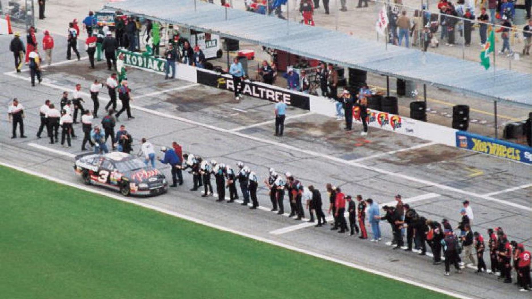 DAYTONA BEACH, FL - FEBRUARY 15: Dale Earnhardt Sr. (April 29, 1951 - February 18, 2001) driver of the #3 GM Goodwrench Chevrolet celebrates with every crew member of every team on pit road after winning the 1998 NASCAR Winston Cup Daytona 500 at the Daytona International Speedway on February 15, 1998 in Daytona Beach, Florida. (Photo by ISC Archives via Getty Images)