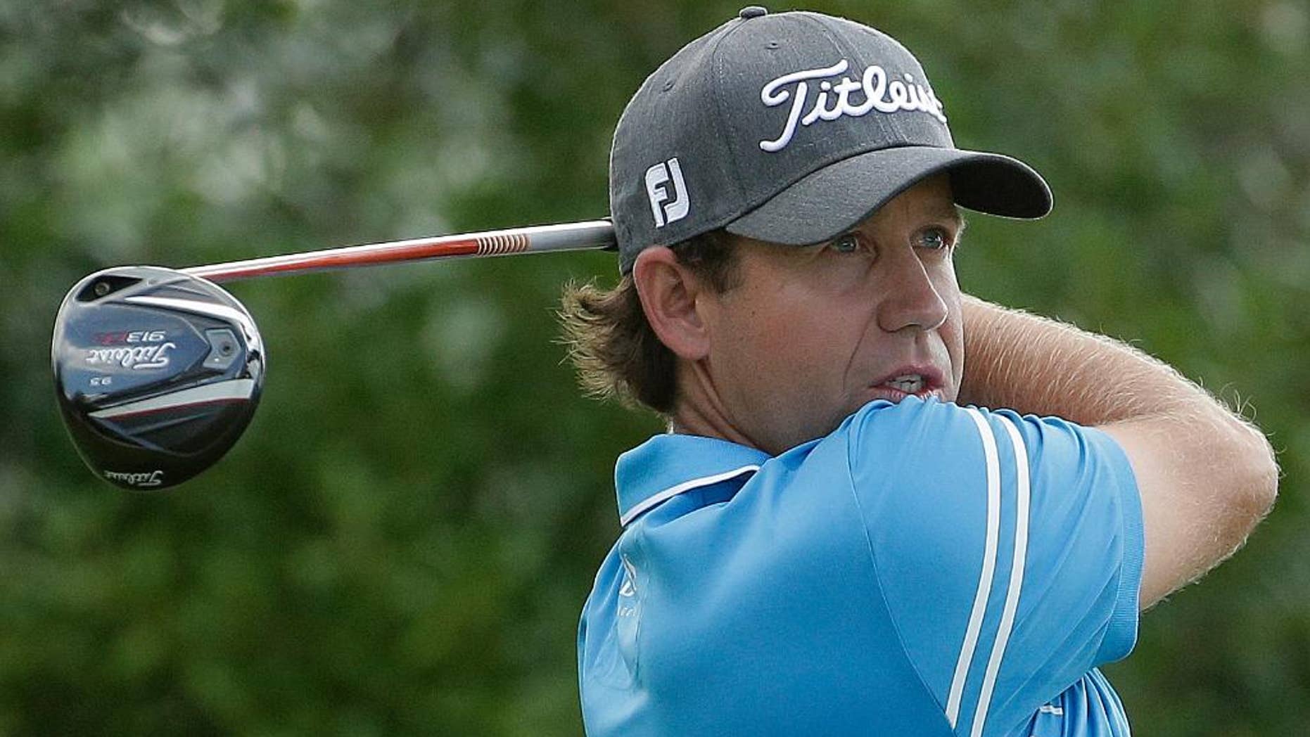 Erik Compton watches his tee shot on the 12th hole during the third round of the U.S. Open golf tournament in Pinehurst, N.C., Saturday, June 14, 2014. (AP Photo/Charlie Riedel)