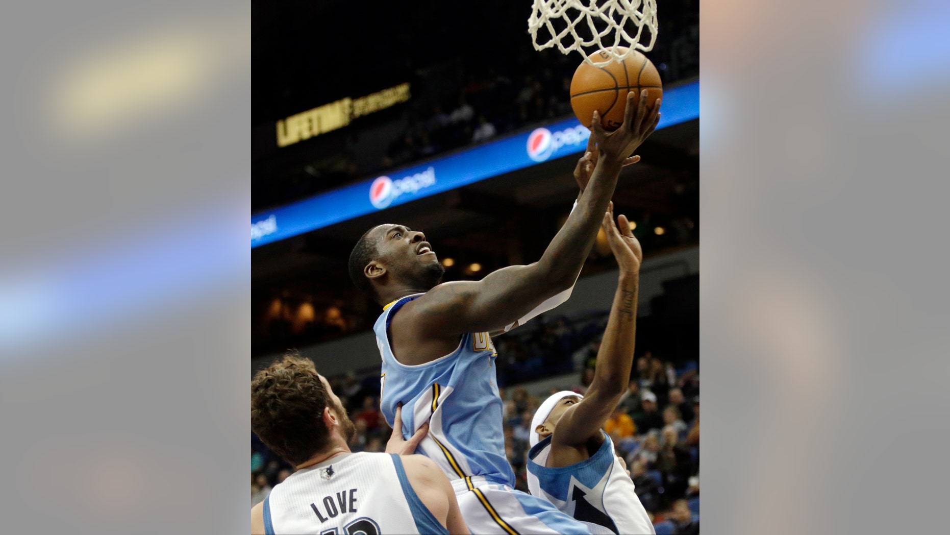 Denver Nuggets's J.J. Hickson lays up a shot as Minnesota Timberwolves' Kevin Love stands near in the second half of an NBA basketball game Wednesday, Feb. 12, 2014, in Minneapolis. The Timberwolves won 117-90. Hickson scored 14 points and had 13 rebounds. (AP Photo/Jim Mone)