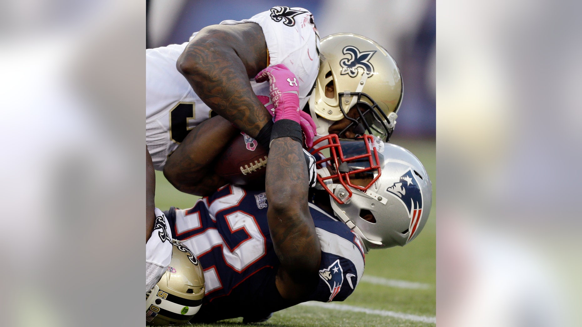 FILE - In this Oct. 13, 2013, file photo, New Orleans Saints outside linebacker Parys Haralson, top, tackles New England Patriots running back Stevan Ridley (22) in the first half of an NFL football game in Foxborough, Mass. Haralson was happy to be moving closer to family, but didn't otherwise know what to expect when he was traded from the 49ers to the Saints. Turns out his new club is in the thick of the playoff race as his old team comes to town. (AP Photo/Steven Senne, File)