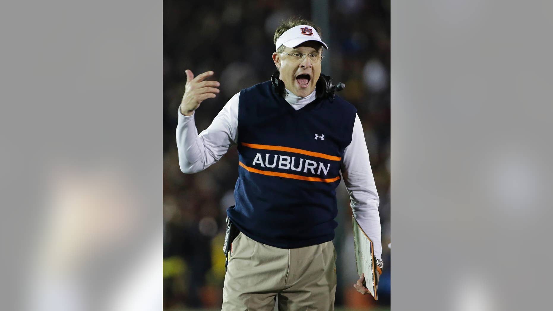 FILE - In this Jan. 6, 2014, file photo, Auburn head coach Gus Malzahn yells during the first half of the NCAA BCS National Championship college football game against Florida State in Pasadena, Calif. Malzahn has a long way to go to challenge Alabama coach Nick Saban's résumé that includes three national titles at Alabama and one at LSU. His Tigers open against his home state team, Arkansas, on Saturday Aug. 30, 2014.(AP Photo/David J. Phillip, File)