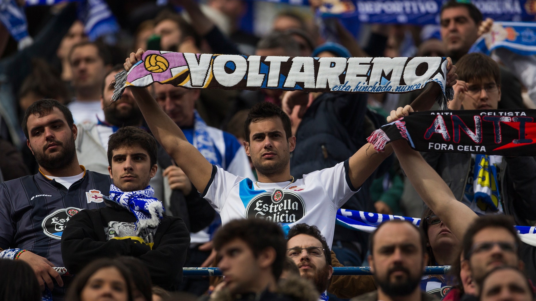 Coruña fan displays a scarf reading 'We will come back' at the Calderon stadium in Madrid, Sunday Nov. 30, 2014.