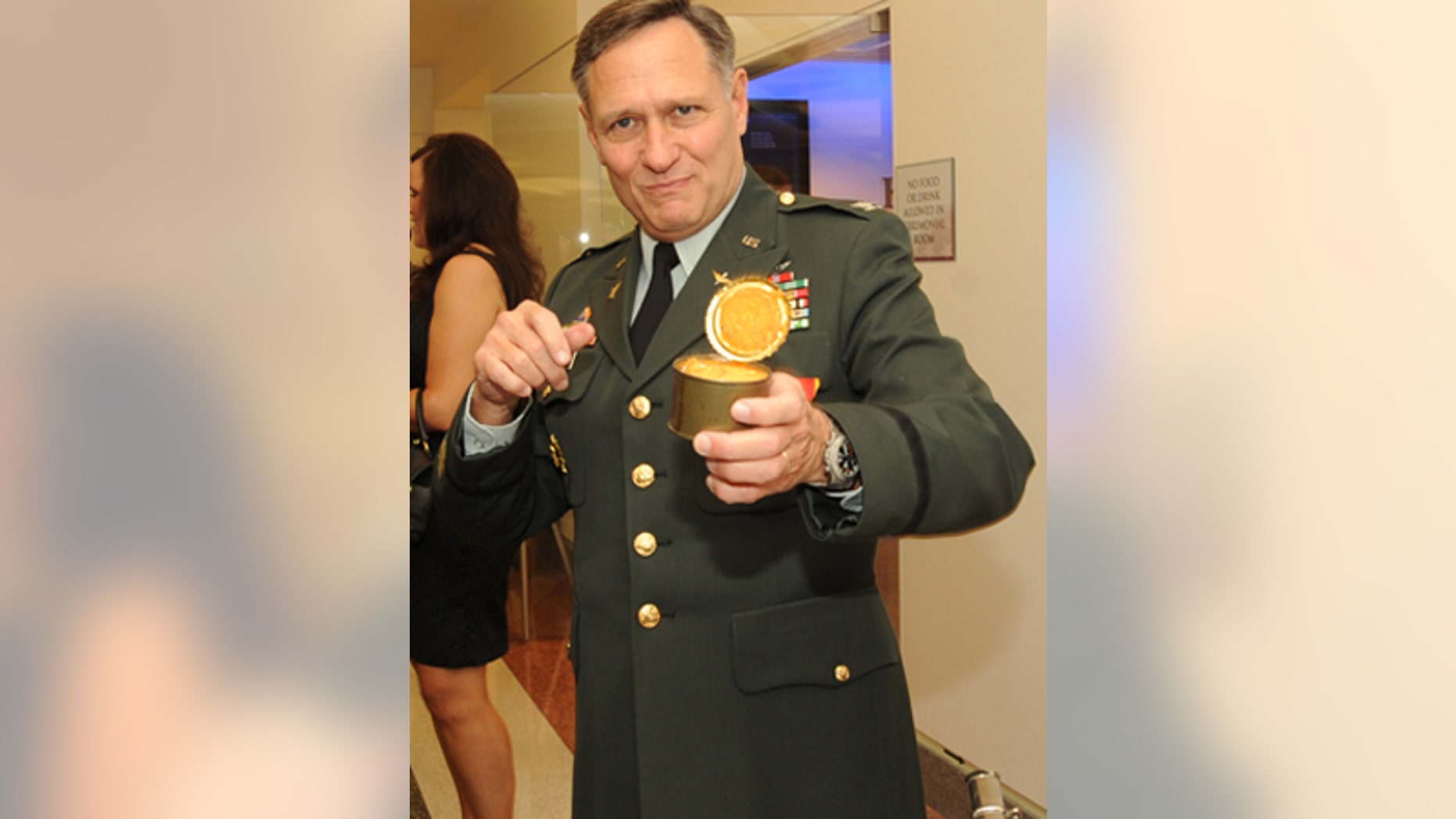 Col. Henry A. Moak Jr. digs in to an Army ration pound cake from 1973 at his retirement party.