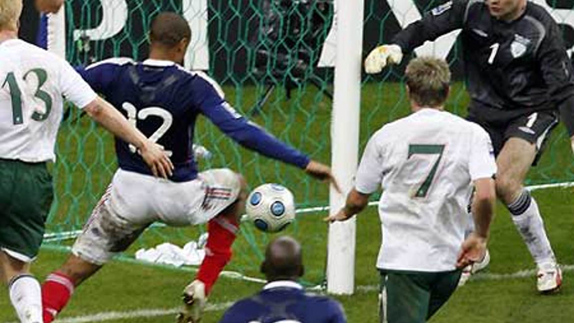 Nov. 18: France's Thierry Henry, second left, passes the ball just before William Gallas (unseen) scored goal for France during World Cup qualifyier.