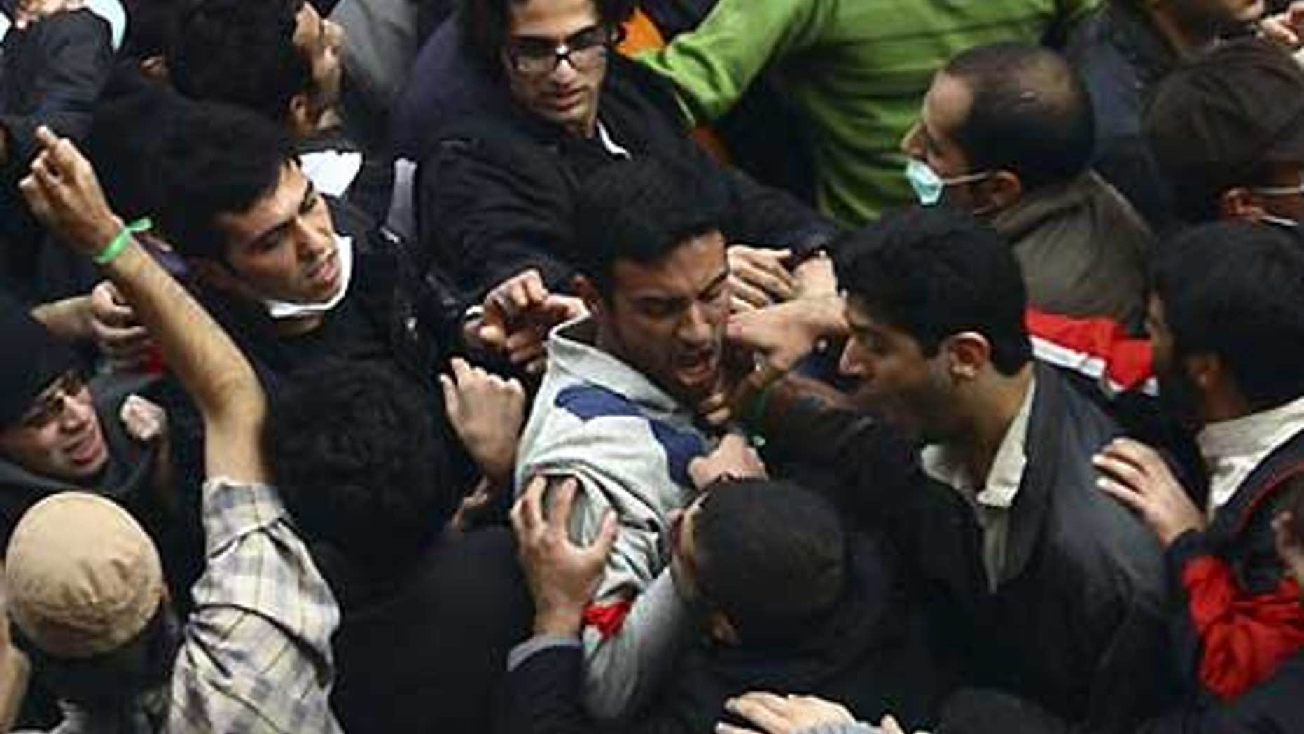 Dec. 7: Pro-reform Iranian students and hard-line students scuffle during their demonstrations at the Tehran University campus in Iran.