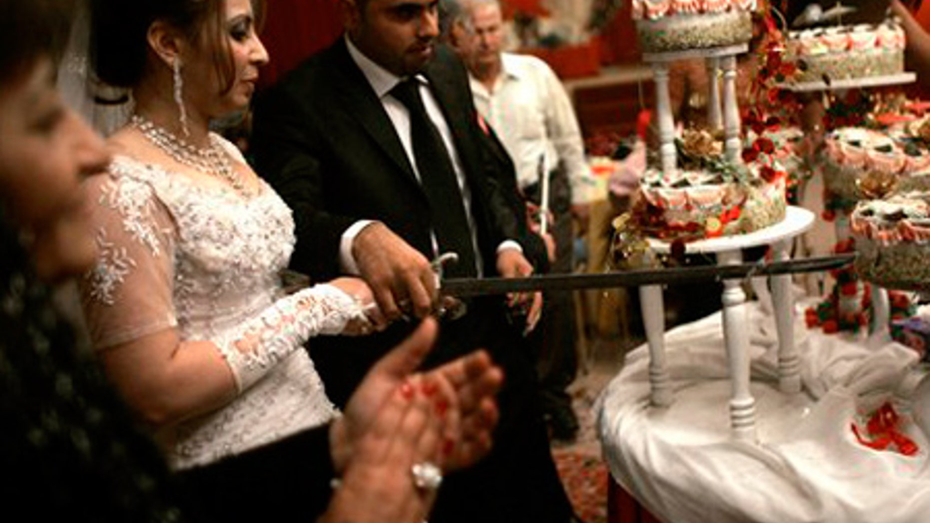 April 16: Maysa Abdul-Rahim and Rahim Nouri cut the wedding cake with a sword at their wedding ceremony in Baghdad, Iraq.