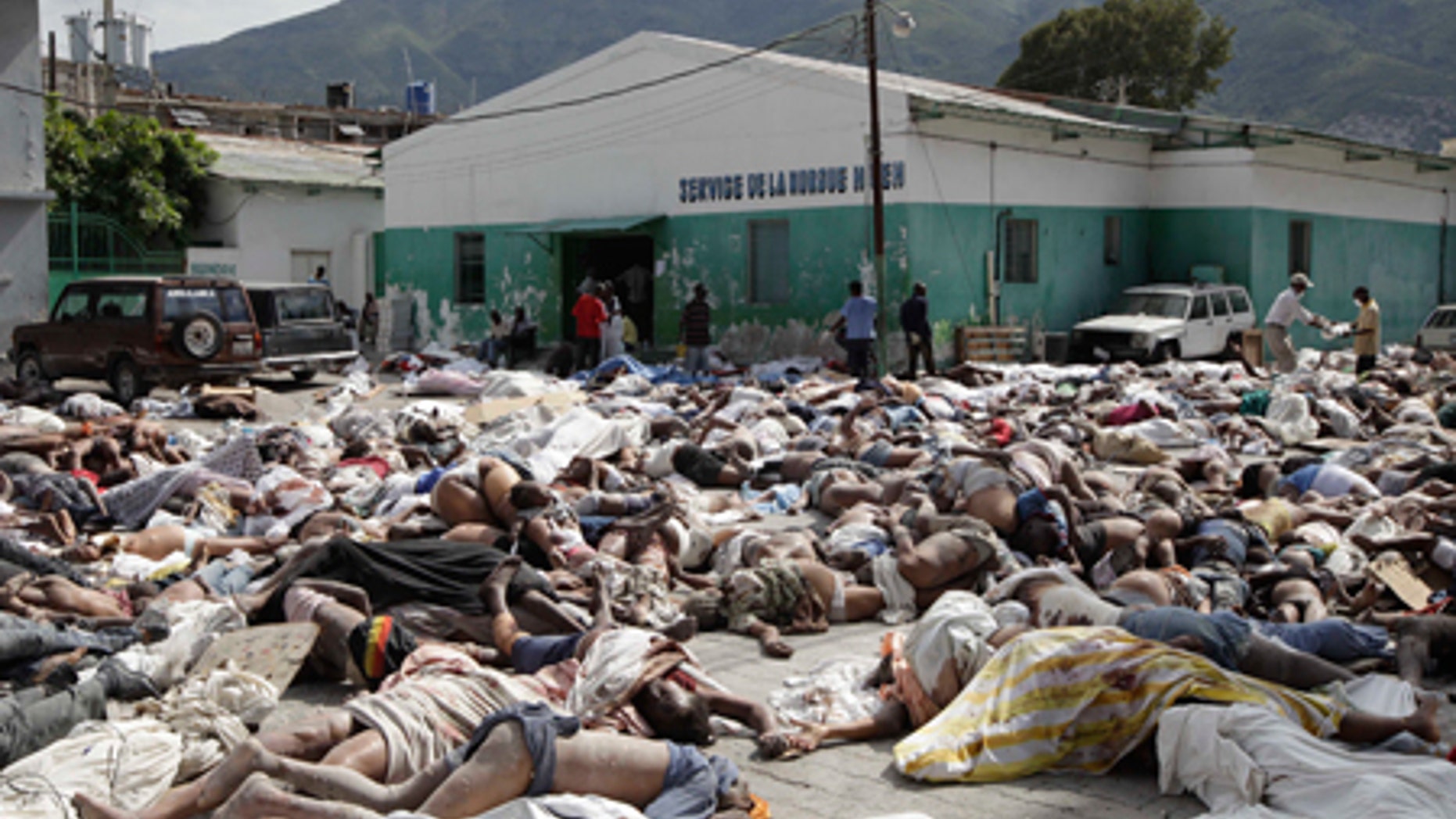 Hundreds of bodies of earthquake victims lay outside the morgue in Port-au-Prince, Thursday, Jan. 14, 2010.