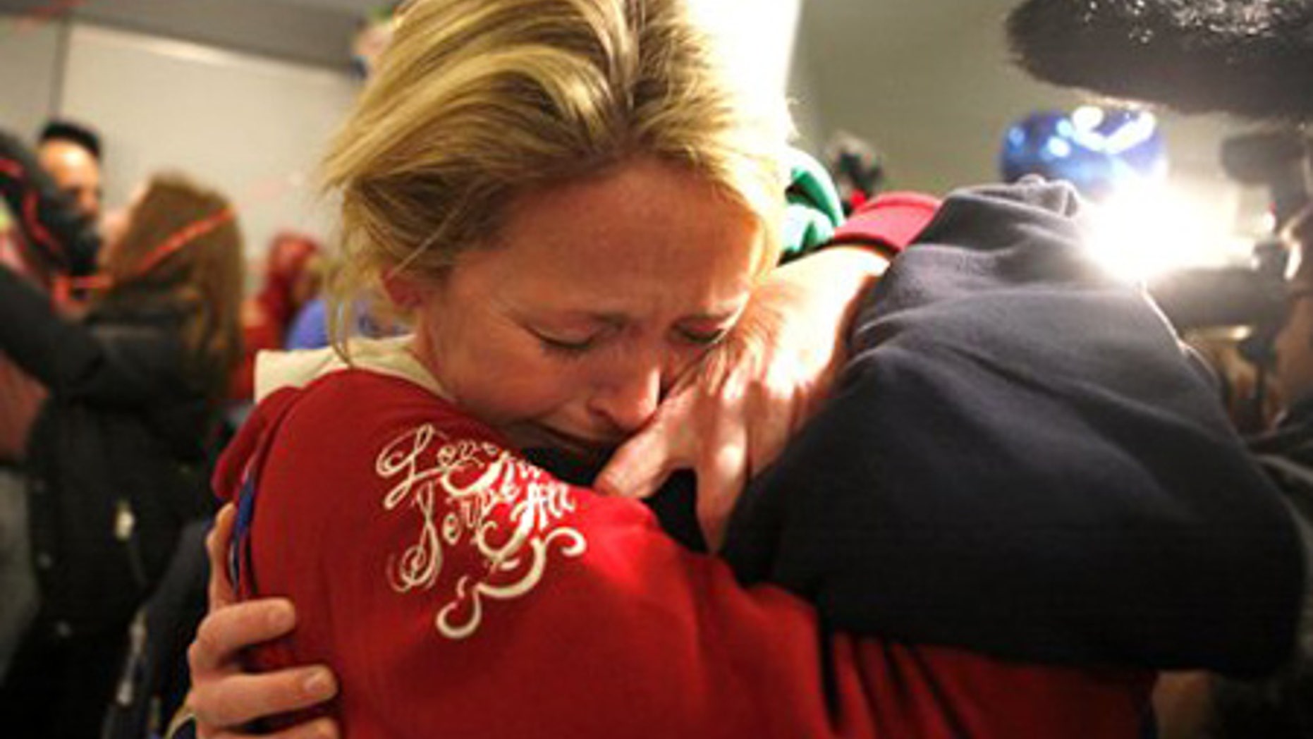 Jan. 15: Linda Callahan embraces her son as she and members of Trinity Methodist return from Haiti.