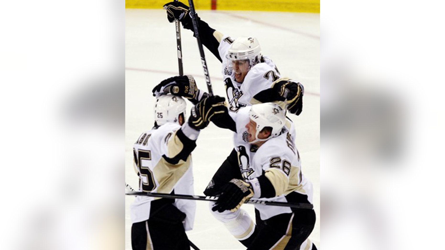 June 12: Pittsburgh Penguins Maxime Talbot, left, celebrates with Evgeni Malkin, from Russia, and Ruslan Fedotenko, from Ukraine, after scoring.