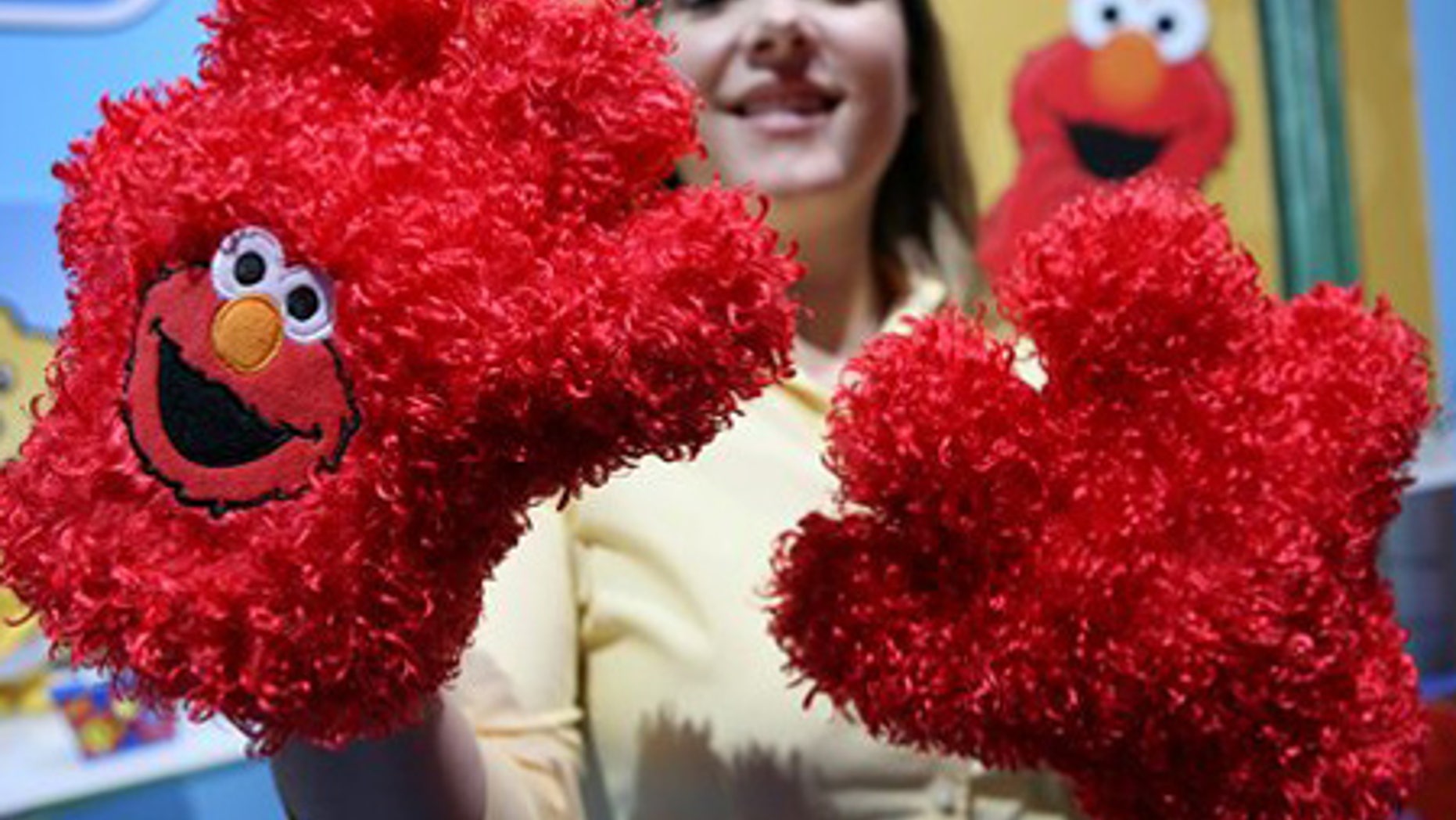 Feb. 18: Taryn Pry with Fisher Price shows off Elmo Tickle Hands, a touch activated toy featuring Sesame Street's Elmo.