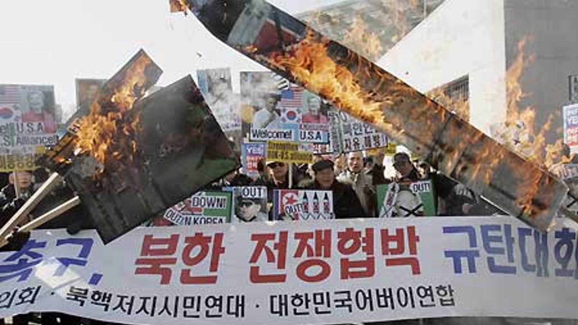 Feb. 17: South Korean protesters burn a portrait of North Korean leader Kim Jong Il and mock North Korean missile during a rally in Seoul.