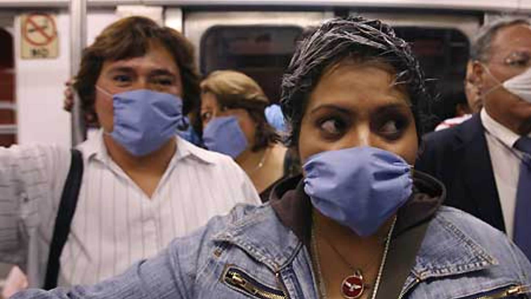 April 24: People wear surgical masks as a precaution against infection inside a subway in Mexico City.