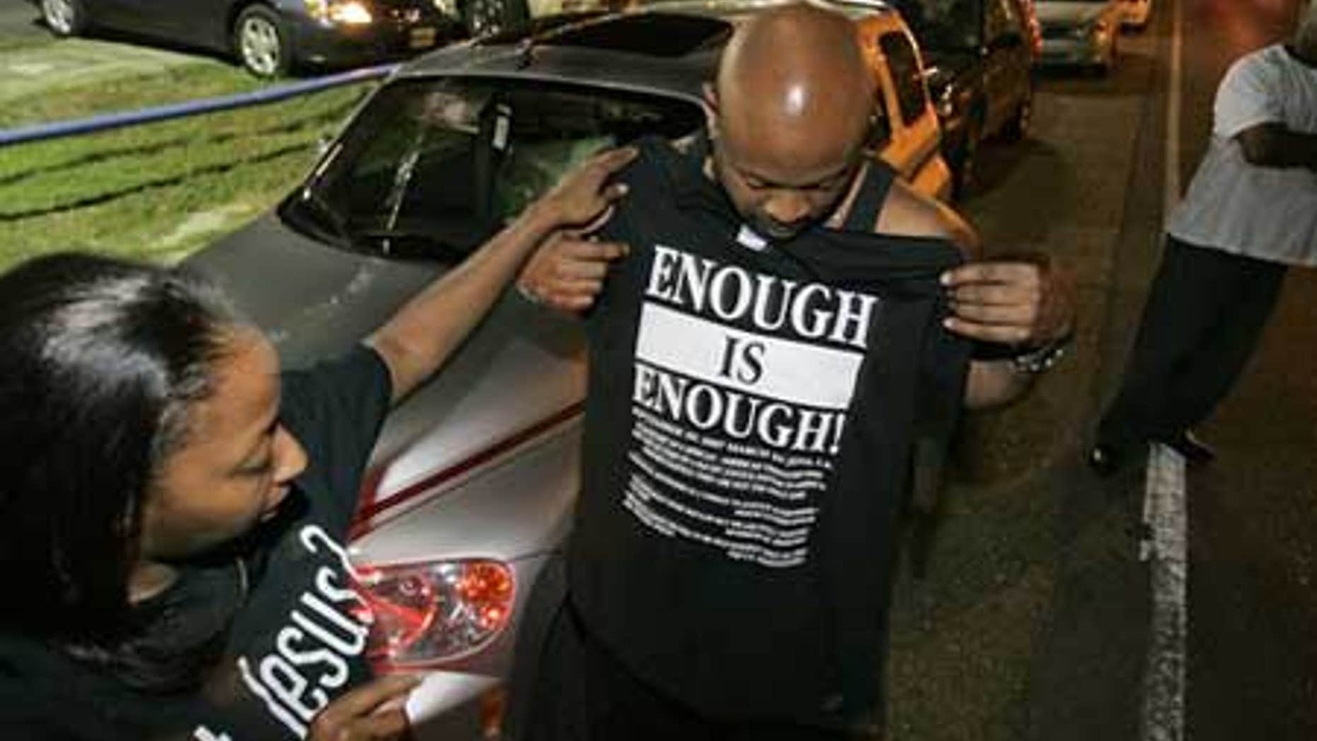 Sept. 20: Andrea Blalock, left, checks out a shirt for her husband Thomas Blalock, both from Stockbridge, Ga. as they prepare for a rally to protest the arrest of the 'Jena 6'in Louisiana. The youngest of the six was released Thursday.