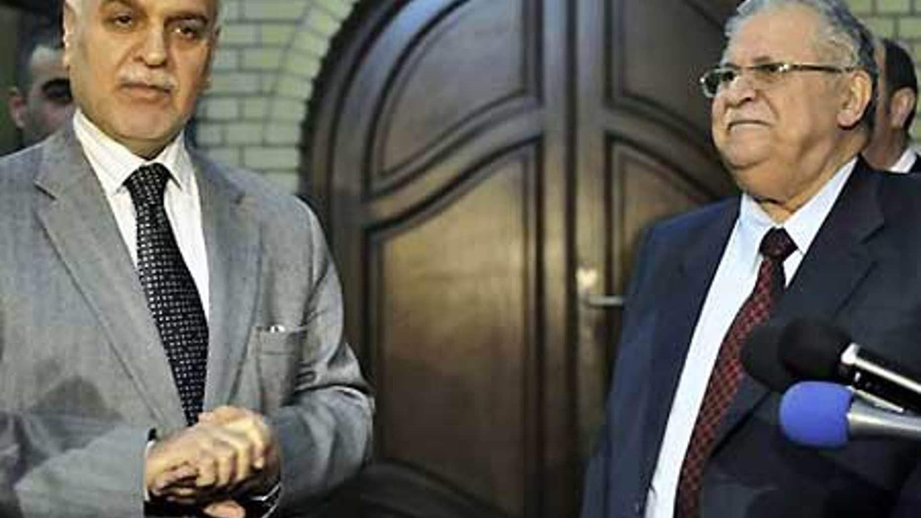 Dec. 4: Iraq's vice president Tariq al-Hashemi, left, and Iraqi President Jalal Talabani, right, hold a joint press conference in Baghdad.