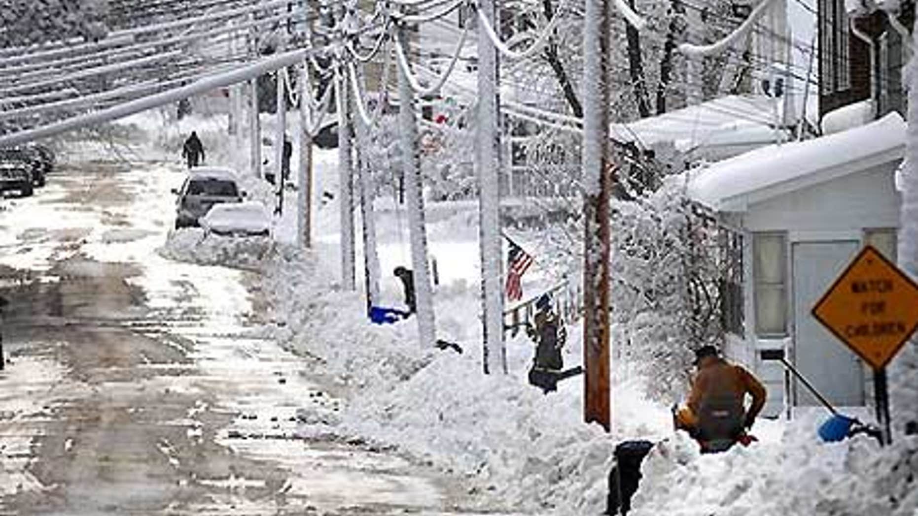 Dec. 9: Residents of Freeport, Ill., shovel a foot of snow on State Avenue. At least 17 have died in the severe winter storms across the U.S.