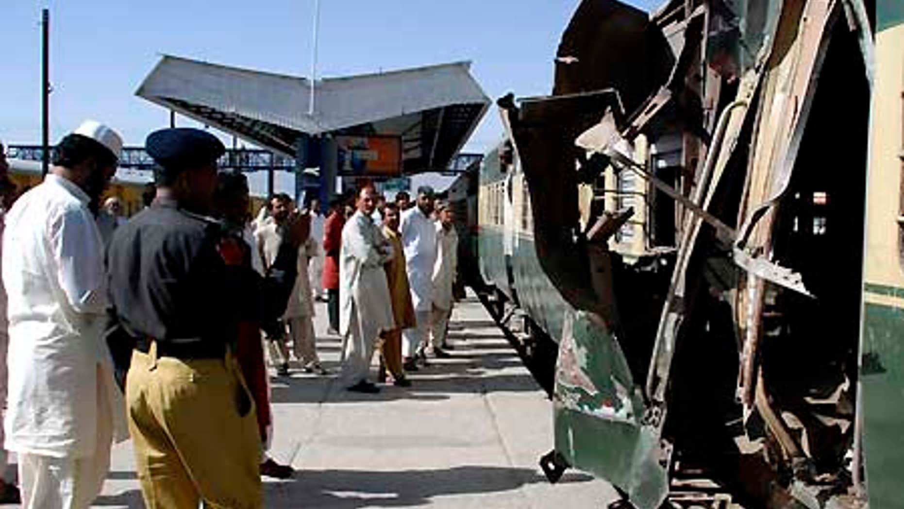 June 11: People look at a compartment of a passenger train damaged by a bomb blast in Quetta, Pakistan.