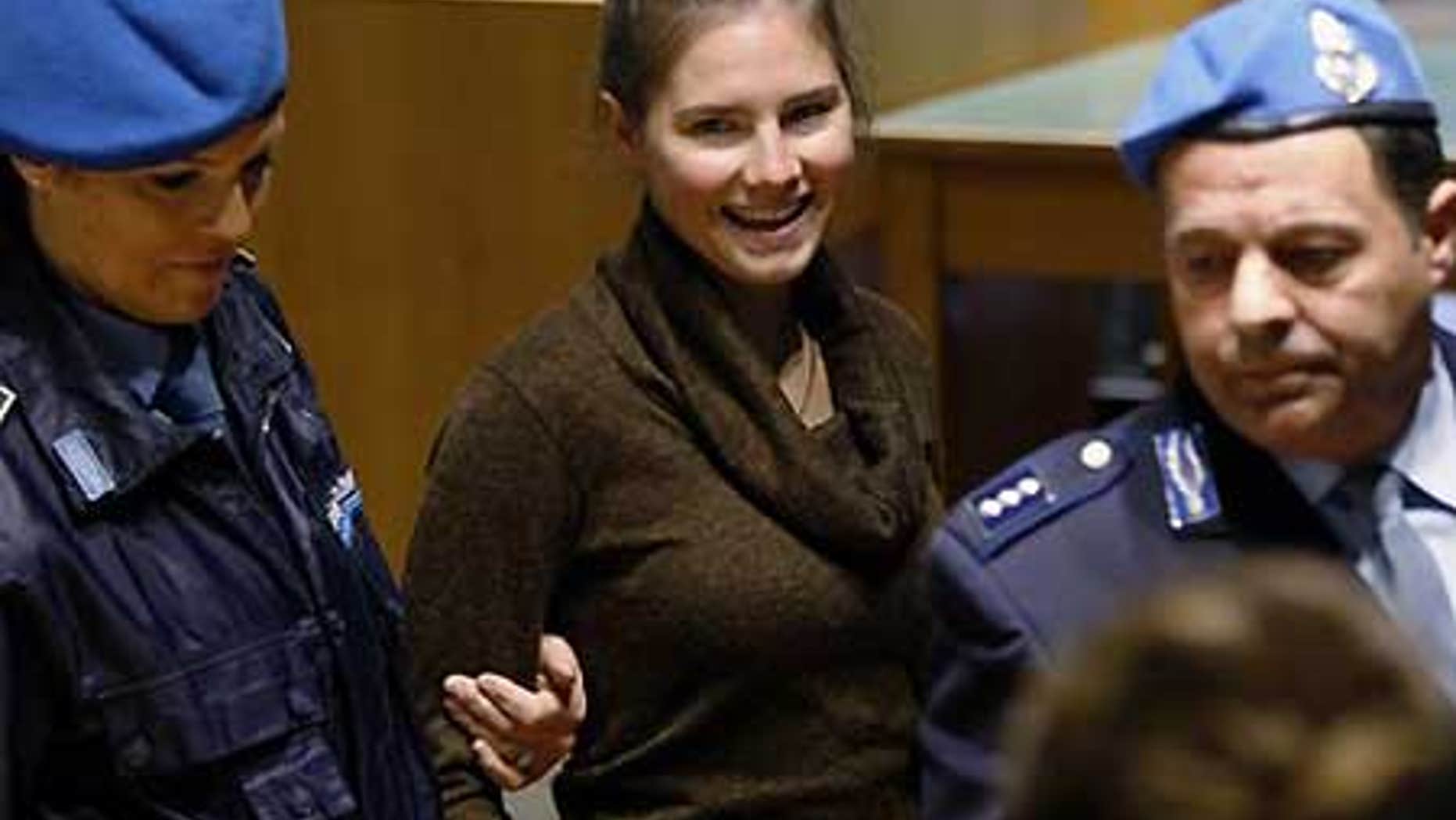 Dec. 2: Amanda Knox, convicted of murdering Meredith Kercher, is accompanied by penitentiary police officers prior to a hearing at the court in Perugia, Italy.