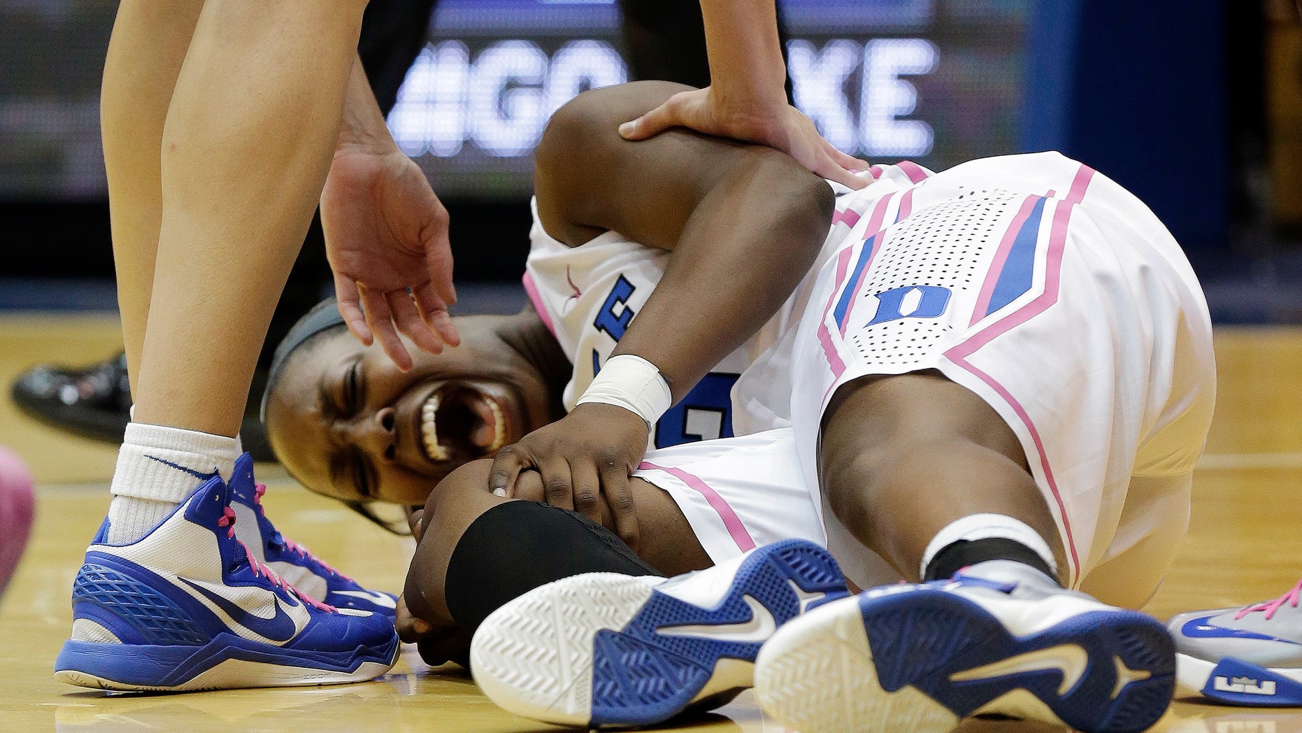 Duke's Chelsea Gray screams out as she grabs her knee following an injury during the first half of an NCAA college basketball game against Wake Forest in Durham, N.C., Sunday, Feb. 17, 2013. (AP Photo/Gerry Broome)