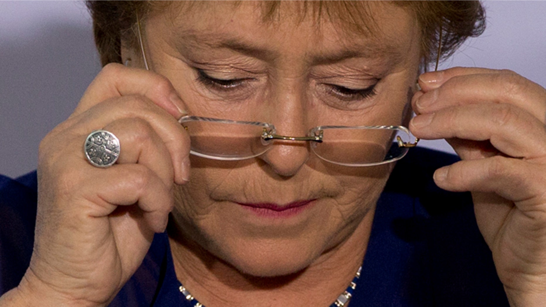 FILE - In this Dec. 9, 2014 file photo, Chile's President Michelle Bachelet puts on her glasses during a 2014 Iberoamerican Summit event in Veracruz, Mexico. Bachelets approval rating is at her lowest level ever, but she said Wednesday, April 8, 2015, that she doesn't care about her popularity, as shes focused on the well-being of Chile and pushing forward needed reforms. (AP Photo/Rebecca Blackwell, File)