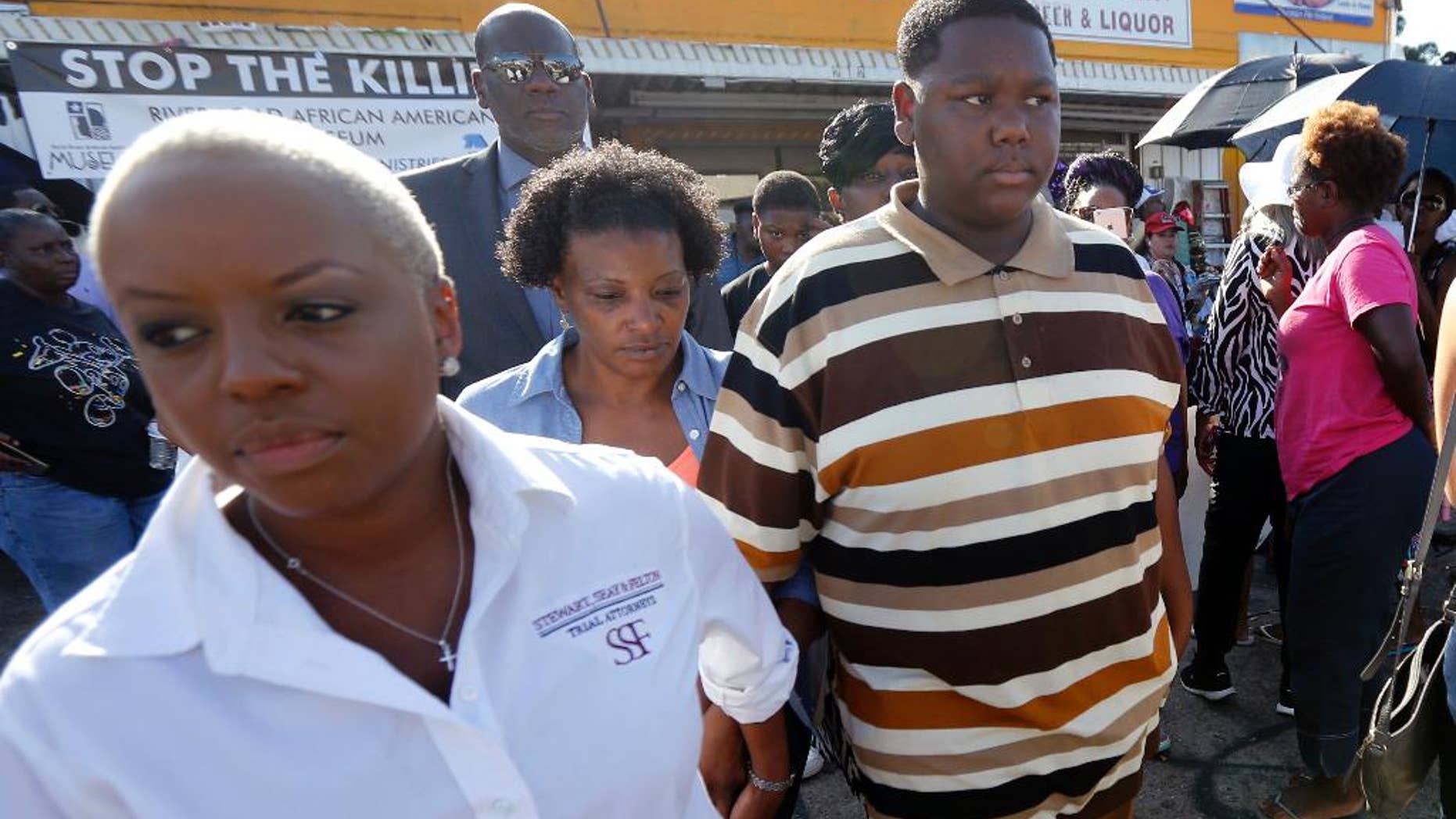 July 13, 2016: Cameron Sterling, center, son of Alton Sterling, who was killed by Baton Rouge police last Tuesday, leaves after speaking to the media outside the the Triple S Food Mart, where his father was killed,in Baton Rouge, La. Cameron called his father a good man and urged protesters not to resort to violence.