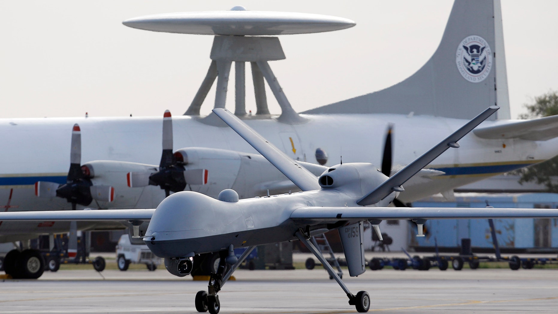 FILE - In this Nov. 8, 2011 file photo, a Predator B unmanned aircraft taxis at the Naval Air Station in Corpus Christi, Texas. The Pentagon for the first time is considering scaling back the massive build-up of drones conducted in the past few years, both to save money and to adapt to new areas of operation, such as Asia, as the Afghanistan war winds down. The downsizing would not affect the current drone campaign against terror suspects in Afghanistan, Pakistan, Yemen and elsewhere. (AP Photo/Eric Gay, File)