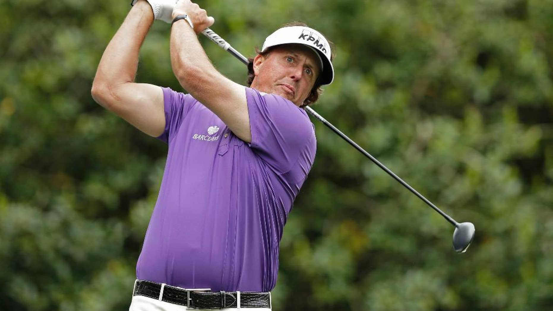 Phil Mickelson watches his tee shot on the 14th hole during the second round of the Wells Fargo Championship golf tournament in Charlotte, N.C., Friday, May 2, 2014. (AP Photo/Chuck Burton)