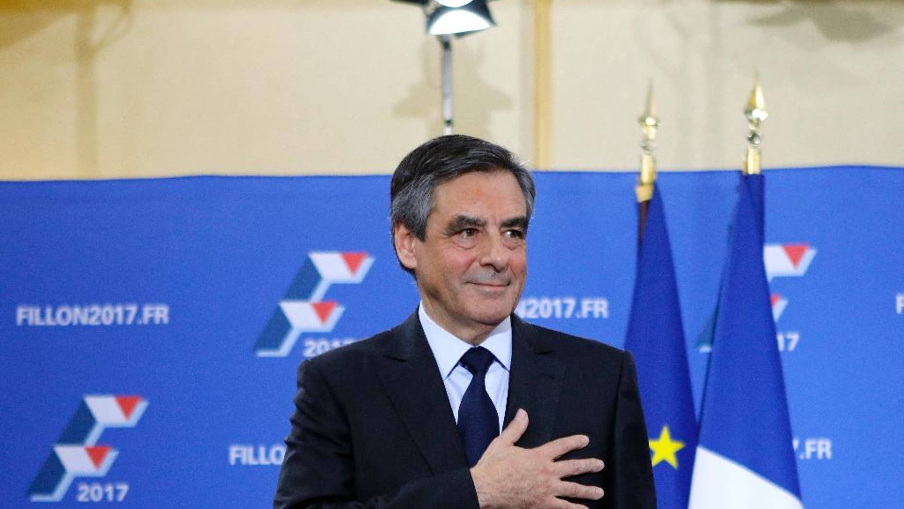 Francois Fillon puts his hand on his hear after delivering a speech following the conservative presidential primary Sunday, Nov. 27, 2016 in Paris. Fillon won France's first-ever conservative presidential primary Sunday after promising drastic free-market reforms and a crackdown on immigration and Islamic extremism, beating a more moderate rival who had warned of encroaching populism. (AP Photo/Kamil Zihnioglu)