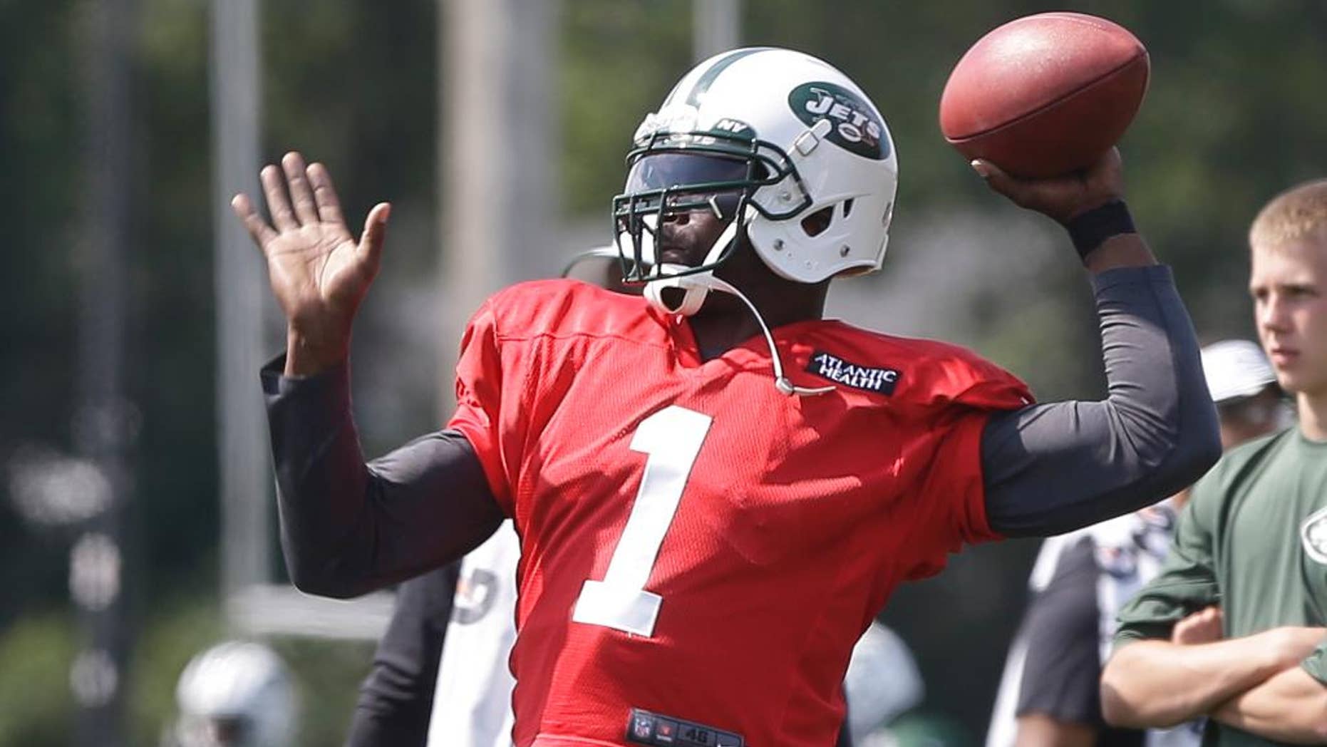 New York Jets' Michael Vick (1) throws a pass at practice during NFL football training camp Saturday, July 26, 2014, in Cortland, N.Y. (AP Photo/Frank Franklin II)