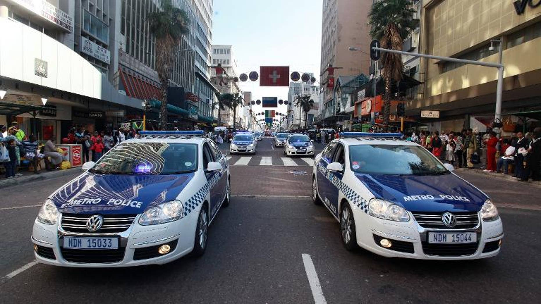 Members of the Metro Police drive their cars in Durban on July 8, 2010