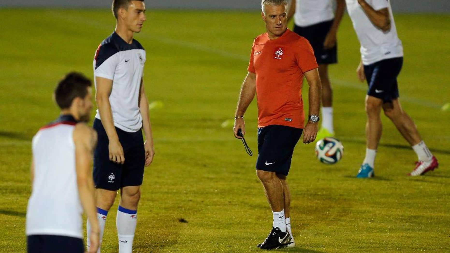 France's head coach Didier Deschamps walks on the field during an official training session at the Joao Havelange Olympic stadium, in Rio de Janeiro, Brazil, Tuesday, June 24, 2014. France will play its next game against Ecuador in group E of the 2014 soccer World Cup. A draw is enough to guarantee top spot for France, and would also send Ecuador through to the next round if Switzerland fails to beat Honduras in the other match. (AP Photo/David Vincent)