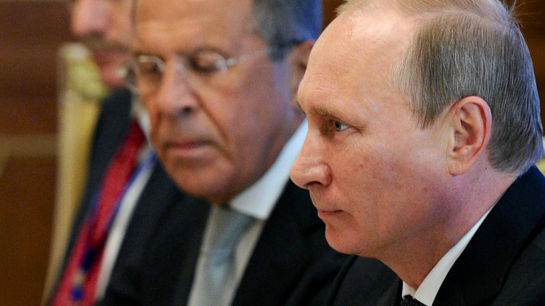 Sept. 11, 2014 - Russian President Vladimir Putin, right, speaks during his meeting with Chinese President Xi Jinping, at a summit in in Dushanbe, Tajikistan, as Russian Foreign Minister, Sergey Lavrov listens. New European Union sanctions against Russia announced Friday punish Moscow for what the West sees as efforts to destabilize Ukraine.