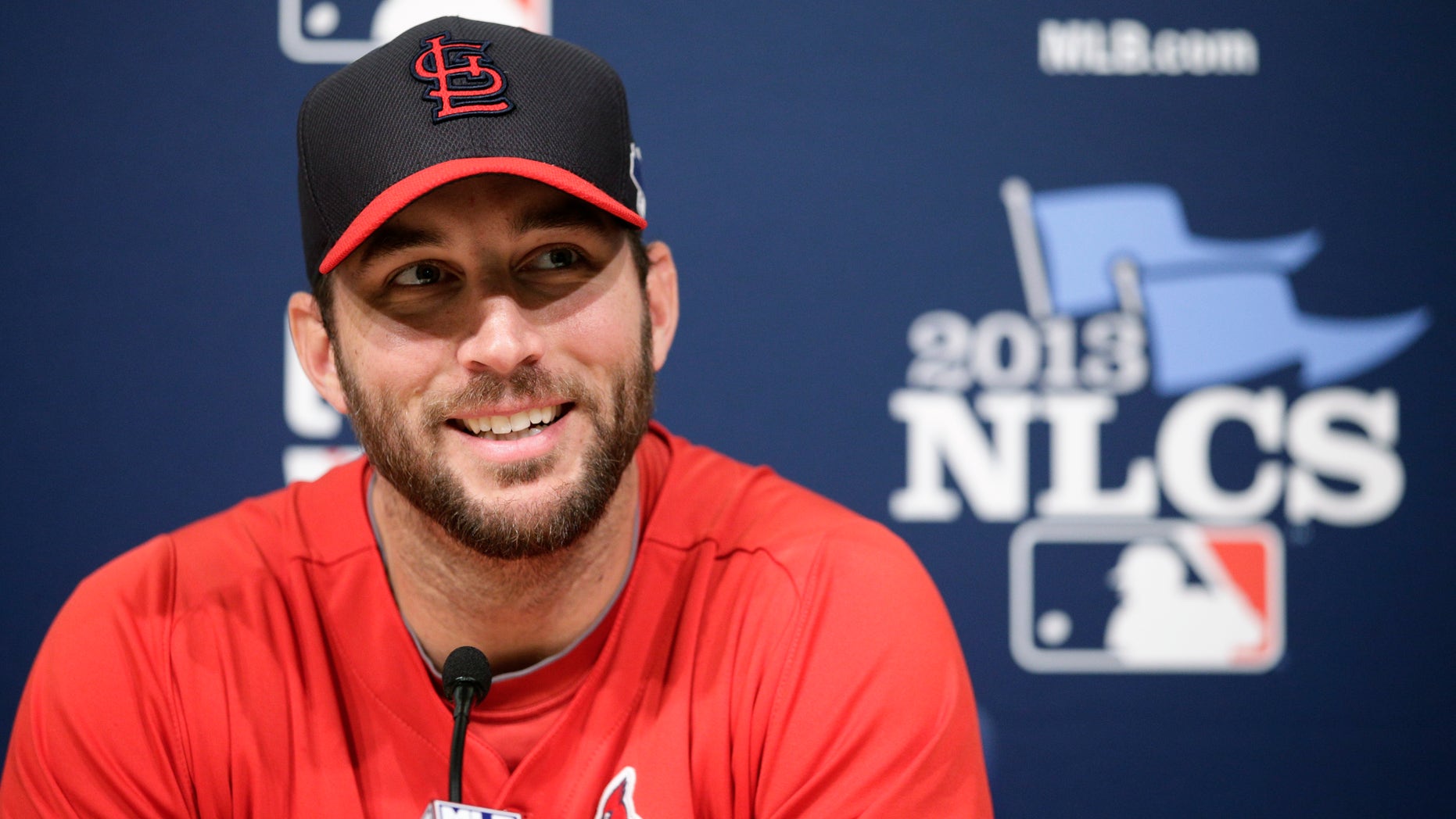 St. Louis Cardinals starting pitcher Adam Wainwright smiles while talking to reporters during practice in preparation for Monday's Game 3 of the National League baseball championship series against the Los Angeles Dodgers, on Sunday, Oct. 13, 2013, in Los Angeles. (AP Photo/Jae C. Hong)