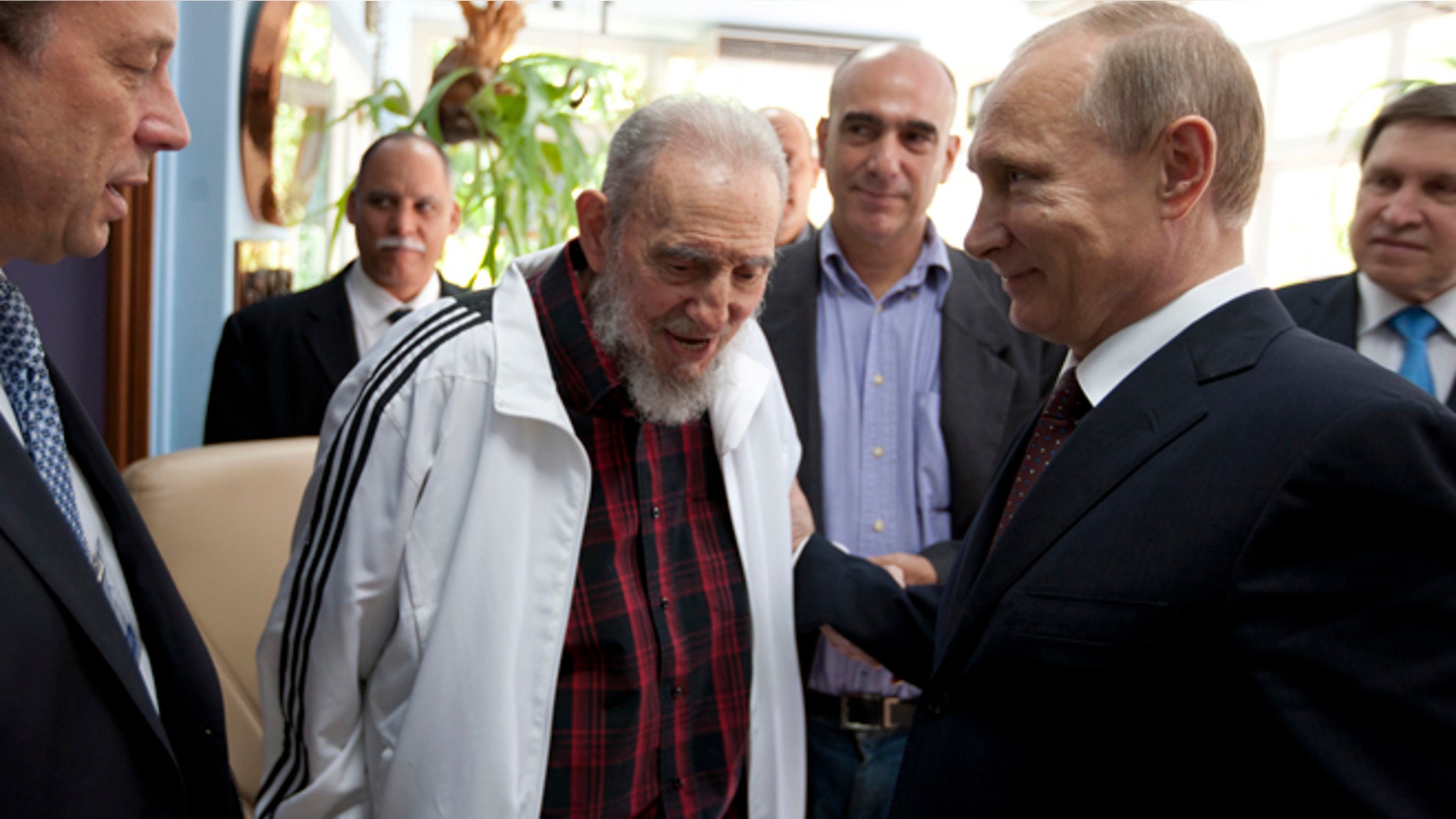 Cuba's Fidel Castro, center, meets with Russia's President Vladimir Putin, right, in Havana, Cuba, Friday, July 11, 2014. Putin began a Latin American tour aimed at boosting trade and ties in the region with a stop Friday in Cuba, a key Soviet ally during the Cold War that has backed Moscow in its dispute with the West over Ukraine. (AP Photo/Alex Castro)