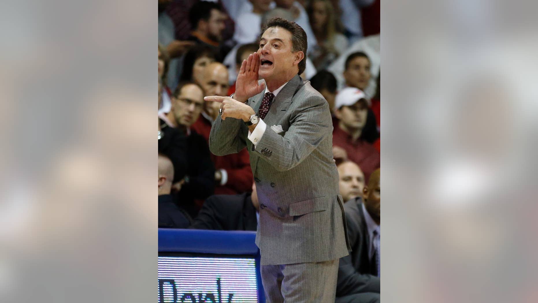 Louisville coach Rick Pitino yells instructions to the team during the first half of an NCAA college basketball game against SMU on Wednesday, March 5, 2014, in Dallas. Pitino has ashes on his forehead for Ash Wednesday. (AP Photo/John F. Rhodes)