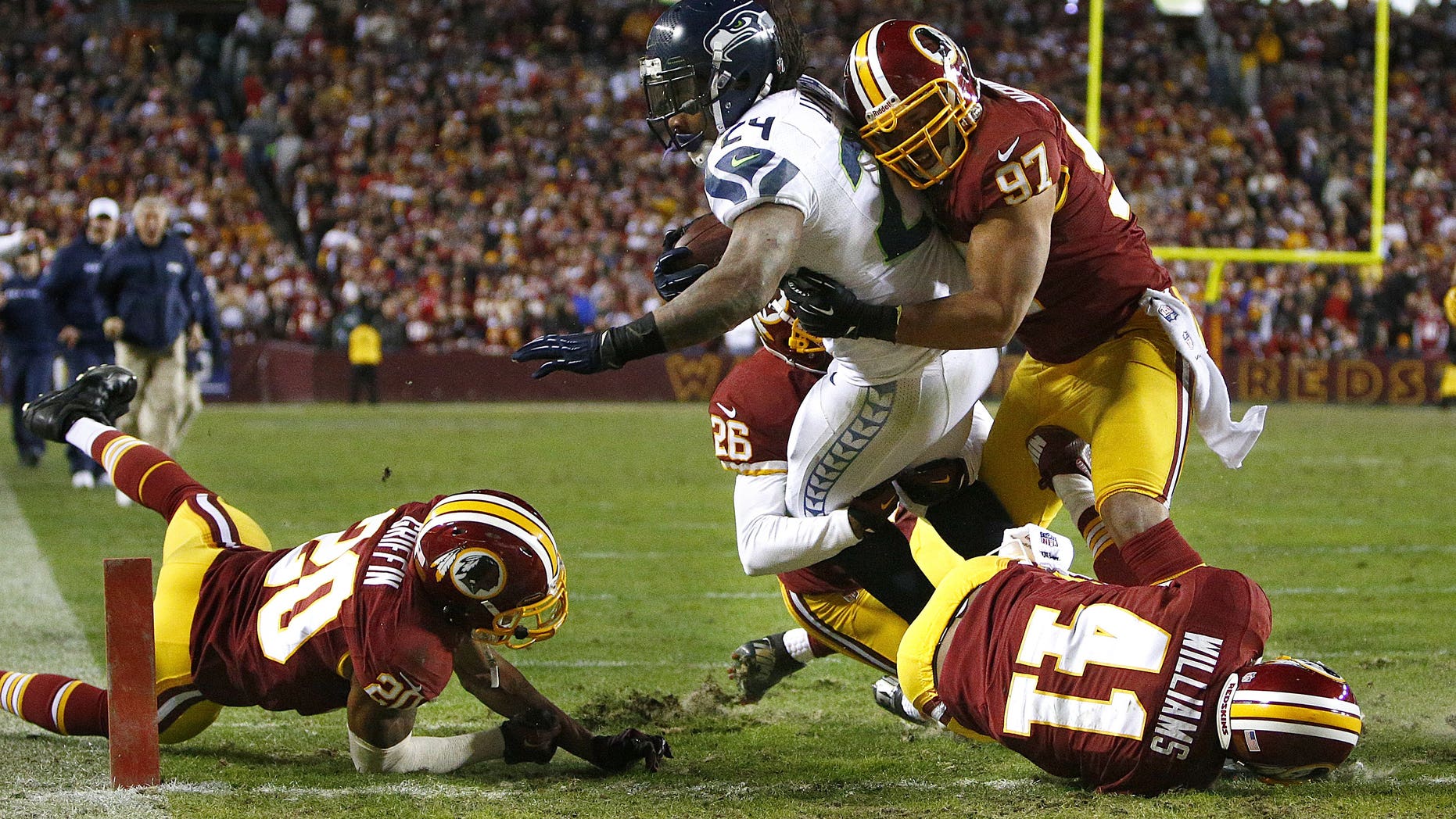 Seattle Seahawks running back Marshawn Lynch gets past several Washington Redskins defenders on his way to a touchdown in the second half of an NFL football wild card playoff game Sunday, Jan. 6, 2013, in Landover, Md. (AP Photo/The Seattle Times, John Lok) SEATTLE OUT MAGS OUT NO SALES MANDATORY CREDIT TV OUT USA TODAY OUT