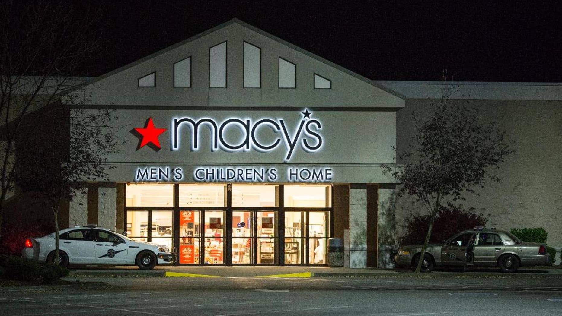 Law enforcement investigate a deadly shooting in the Macy's store at the Cascade Mall in Burlington, Wash., Friday, Sept. 23, 2016. A gunman opened fire in the crowded mall north of Seattle, killing several people and critically wounding another before fleeing Friday night, authorities said. Washington State Patrol spokesman Sgt. Mark Francis said police were searching for a Hispanic man wearing black and armed with a rifle who was last seen walking toward Interstate 5. (AP Photo/Stephen Brashear)