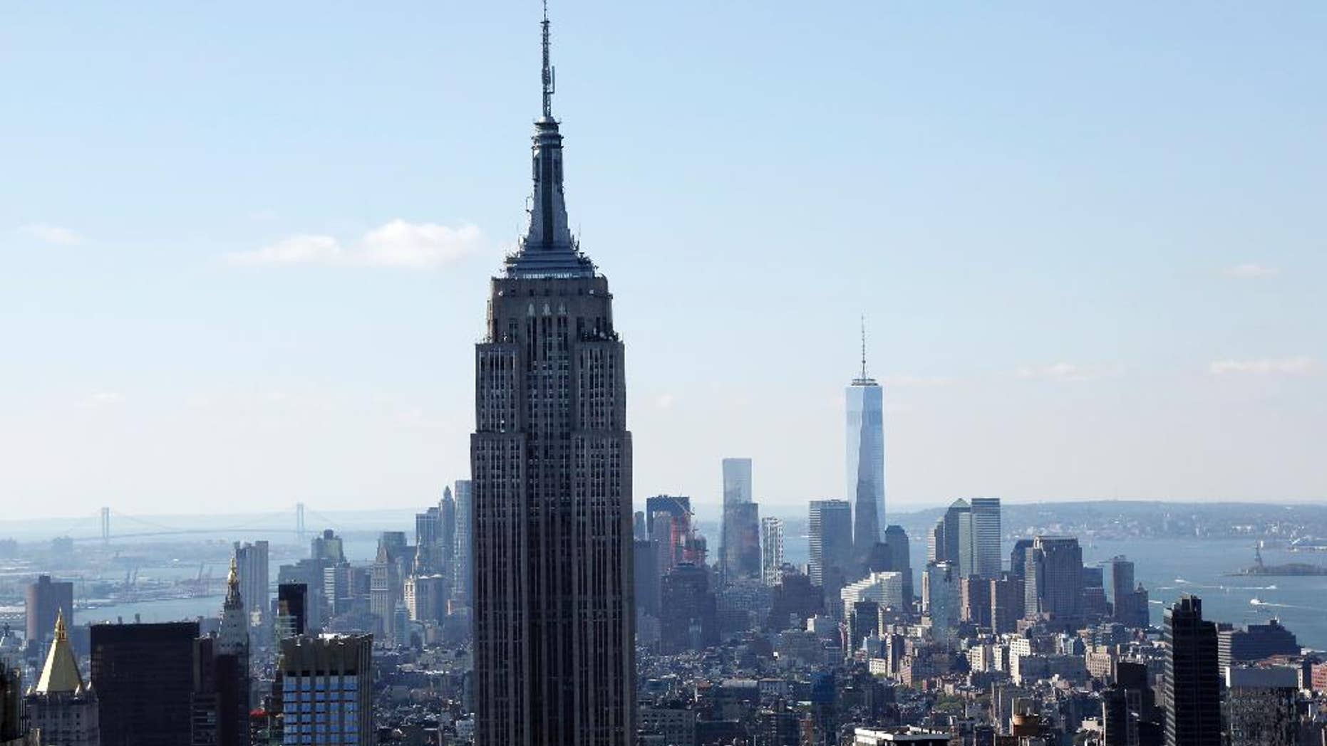 FILE - The Empire State Building and the Manhattan skyline are seen from the Rainbow Room, New York City’s landmark restaurant atop 30 Rockefeller Plaza, in this Sunday, Oct. 5, 2014 file photo. Hundreds of people will take to the stairs at the Empire State Building on Wednesday night Feb. 4, 2015, climbing from the lobby to the 86th floor observatory. They'll be going up the 1,576 steps as part of the 38th annual Empire State Building Run-Up. (AP Photo/Mark Lennihan, File)