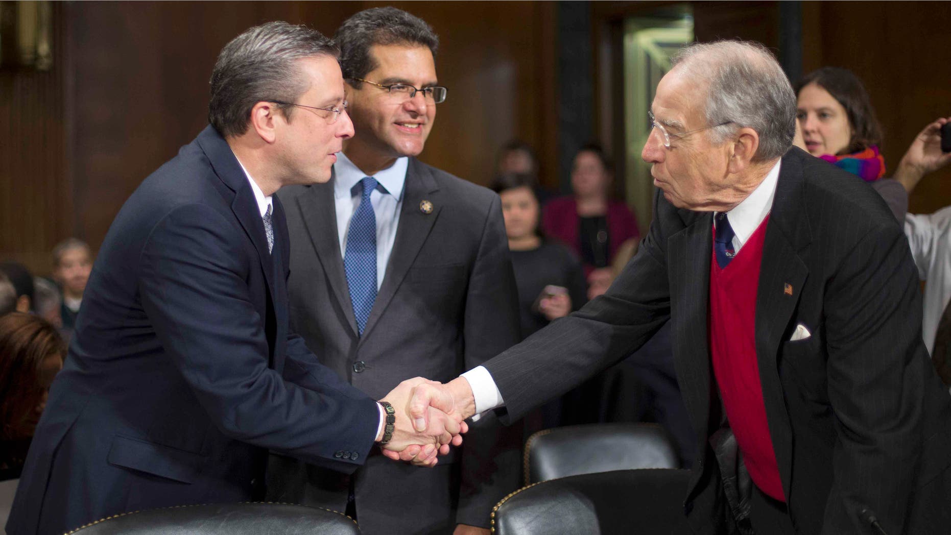 Sen. Chuck Grassley greets Puerto Rico Gov. Alejandro Garcia Padilla on Capitol Hill, Tuesday, Dec. 1, 2015.