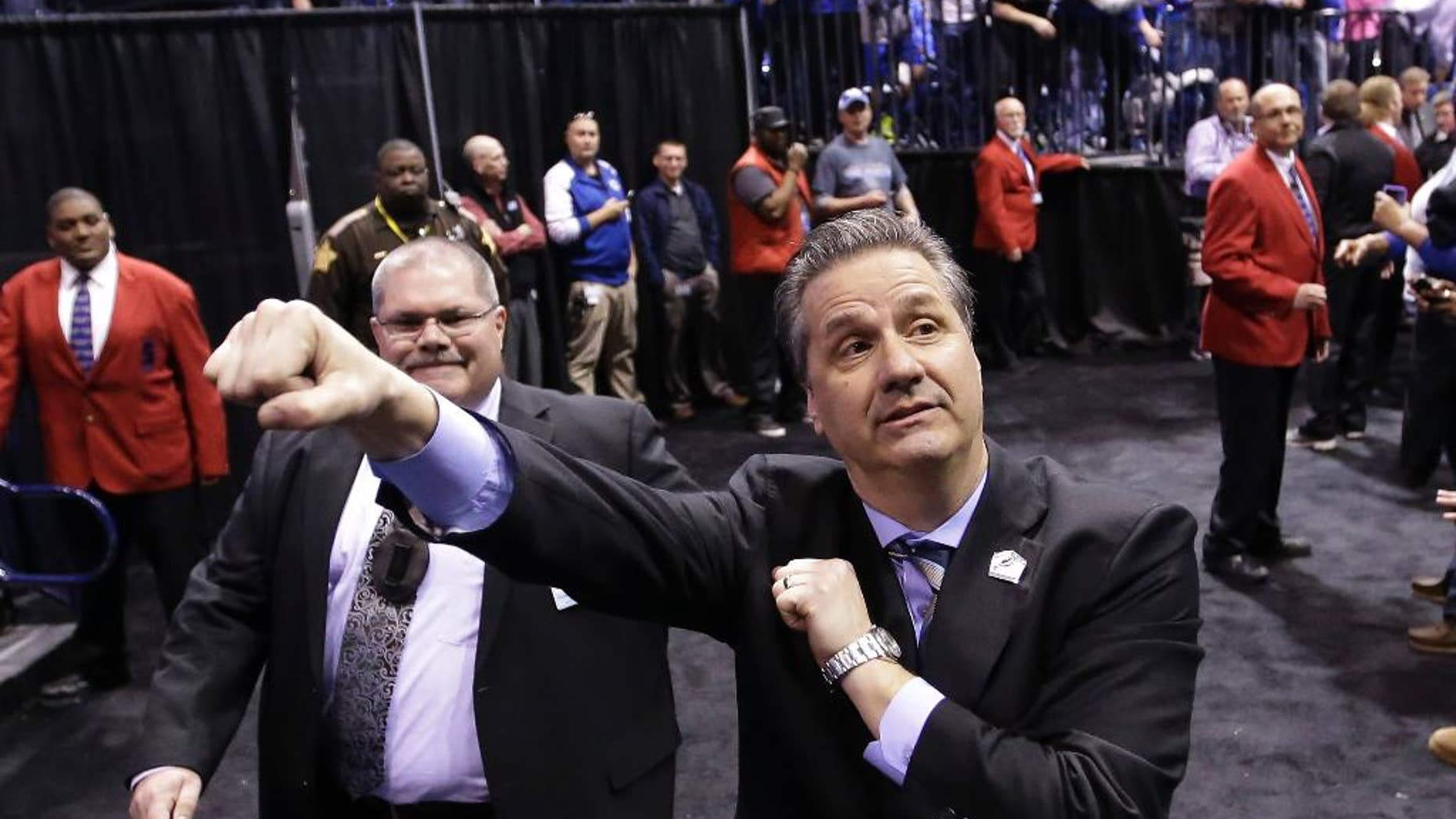 Kentucky head coach John Calipari celebrates after an NCAA Midwest Regional final college basketball tournament game against Michigan Sunday, March 30, 2014, in Indianapolis. Kentucky won 75-72 to advance to the Final Four. (AP Photo/David J. Phillip)