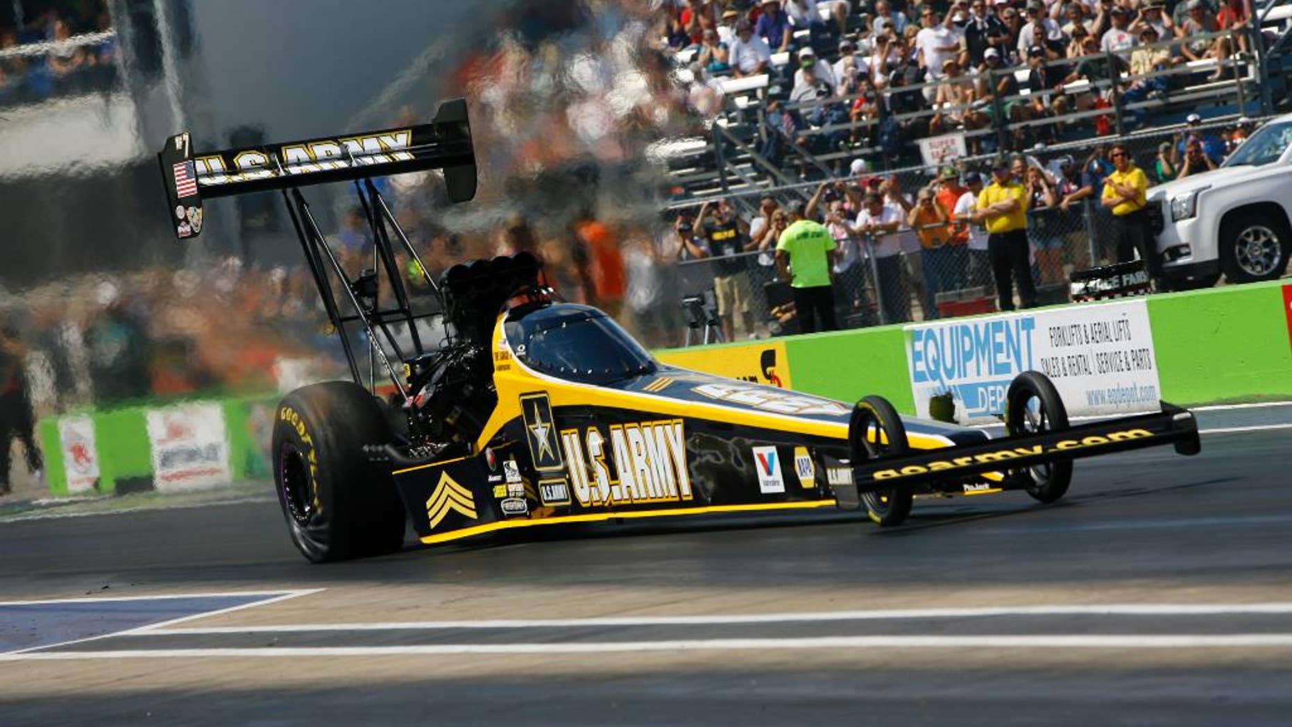 In this photo provided by NHRA, Tony Schumacher drives to victory in Top Fuel at the delayed Pep Boys NHRA Carolina Nationals on Saturday, Sept. 20, 2014, at Texas Motorplex in Ennis, Texas. Schumacher earned his 75th career victory when he defeated Khalid alBalooshi in the final round of the race that was originally started one week ago at zMAX Dragway in Charlotte, N.C. (AP Photo/NHRA, Randy Anderson)