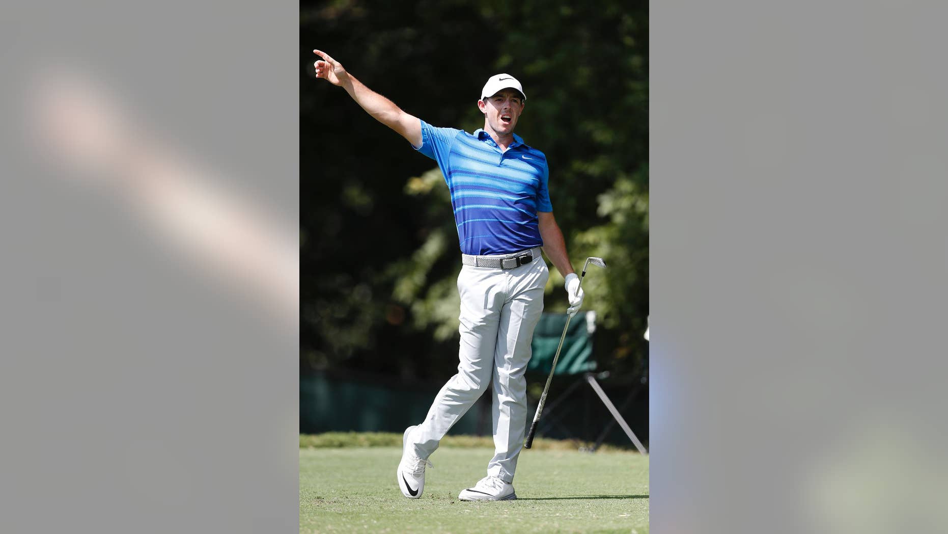 Rory McIlroy warns spectators of his errant shot on the second tee during the second round of play at the Tour Championship golf tournament at East Lake Golf Club Friday, Sept. 23, 2016, in Atlanta. (AP Photo/John Bazemore)